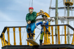 a statue of a pirate and a skeleton on a ship