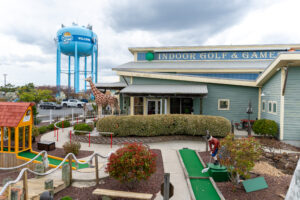 a miniature golf course with a water tower in the background