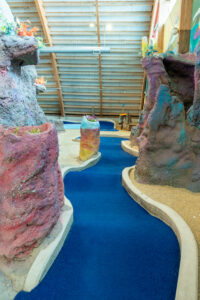 an indoor play area with a water slide