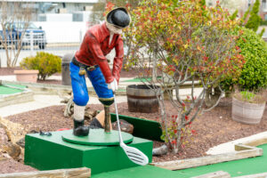 a statue of a man on a miniature golf course