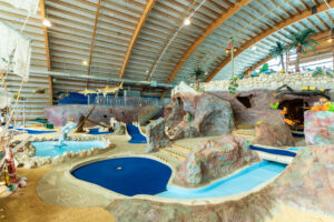 a large indoor water park with slides and slides