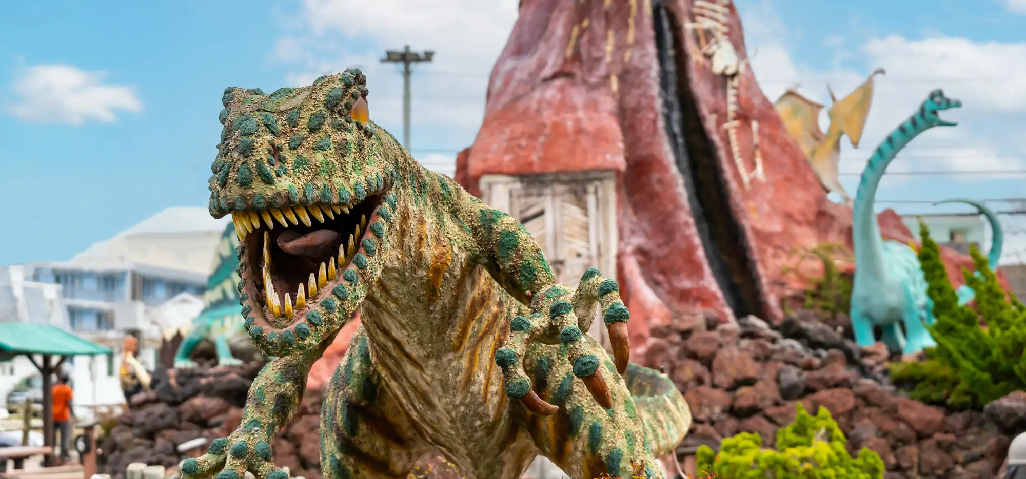 a statue of a dinosaur with its mouth open