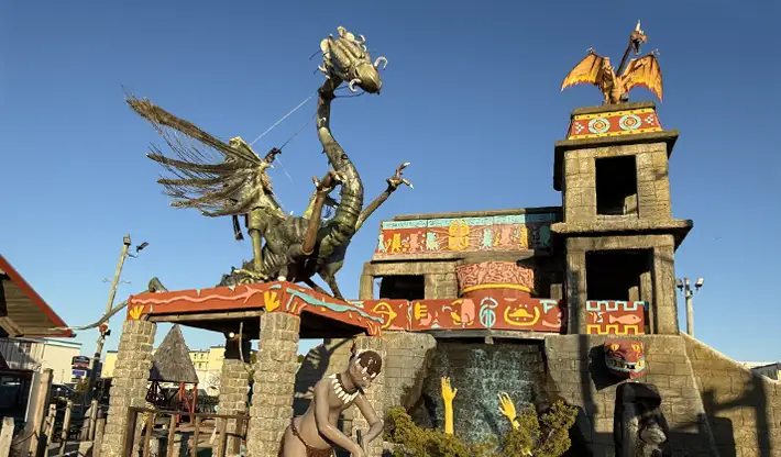 a statue of a dragon on top of a building