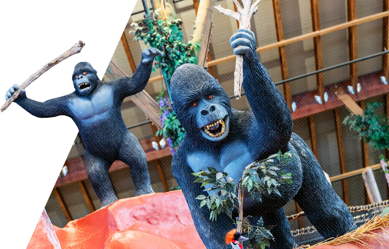 a statue of two gorillas holding up bamboo sticks