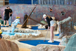 a miniature golf course with people playing miniature golf