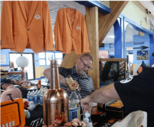 a man standing at a bar pouring a drink