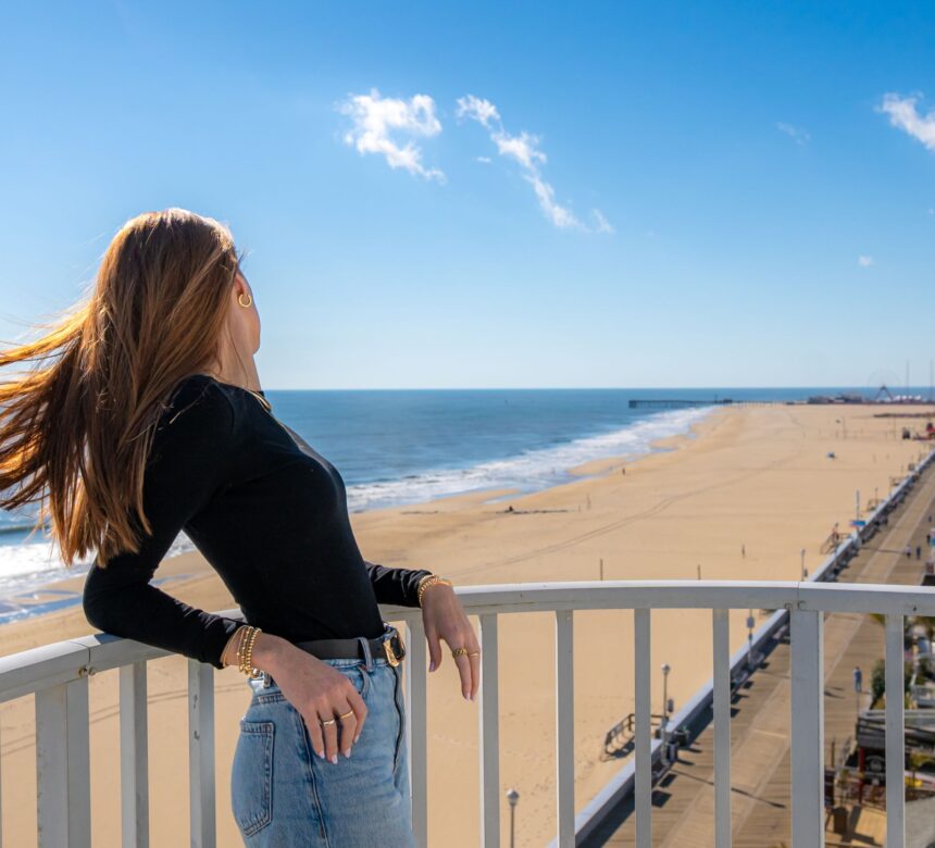 Woman Looking at OCMD Boardwalk from Balcony