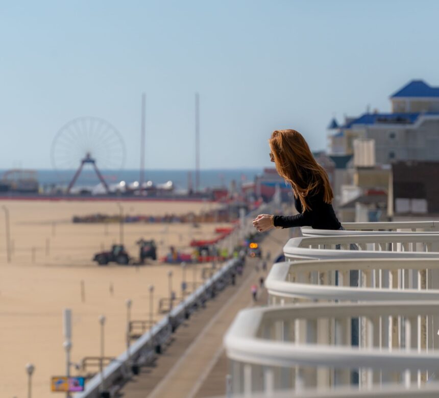 Woman Looking at OCMD Boardwalk from Balcony