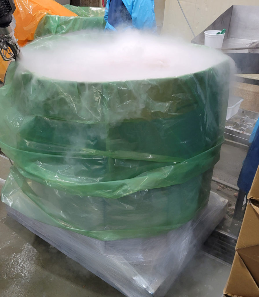 Bulk combo bin wrapped in green film and filled with white vapor