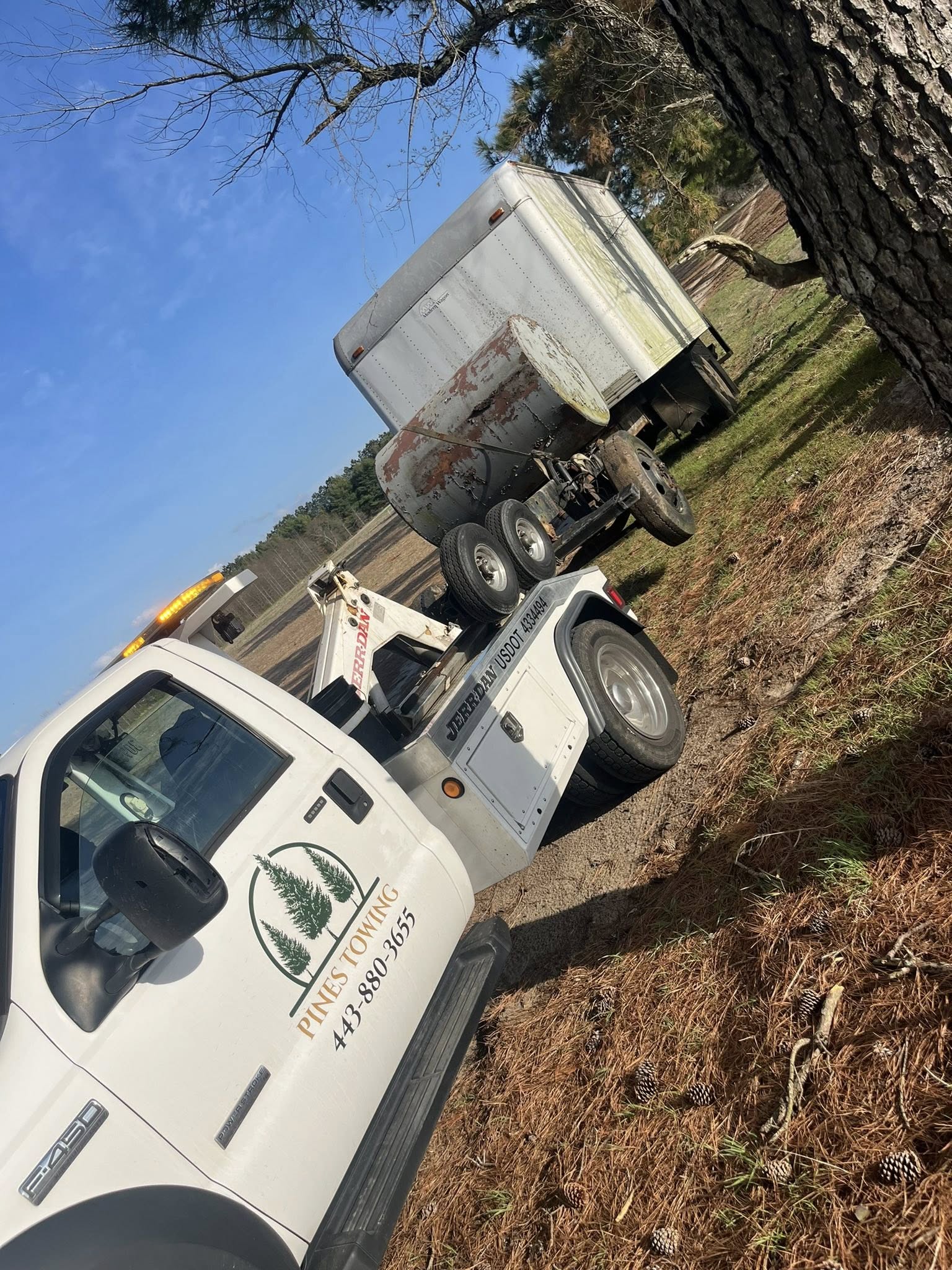 Pines Towing truck towing a trailer