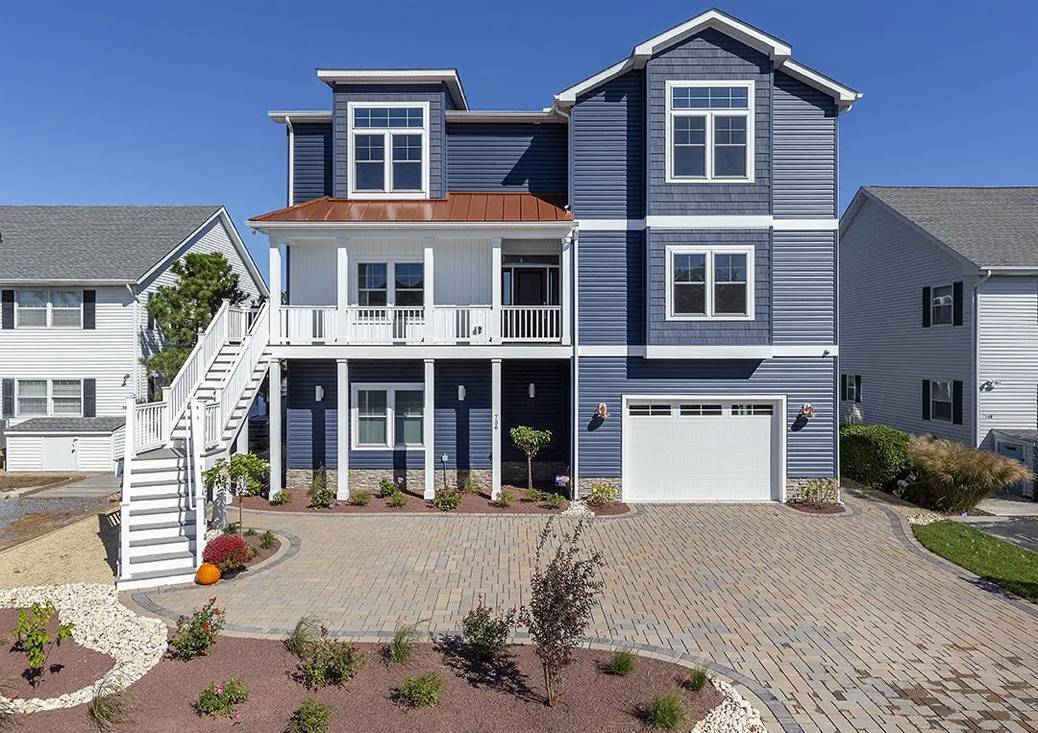 a large blue house with a lot of windows