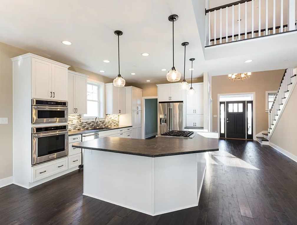 a large kitchen with an island in the middle of it