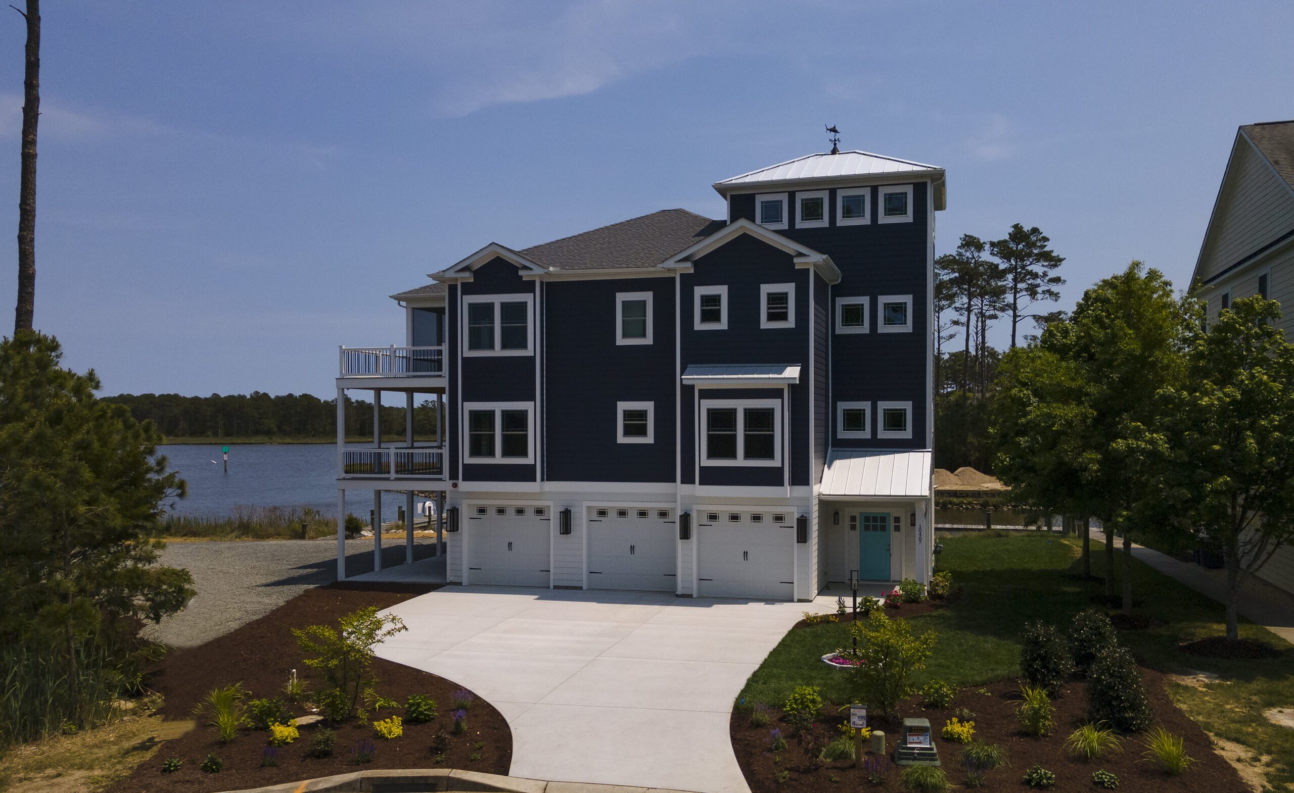 a two story house with a driveway leading to the front of the house
