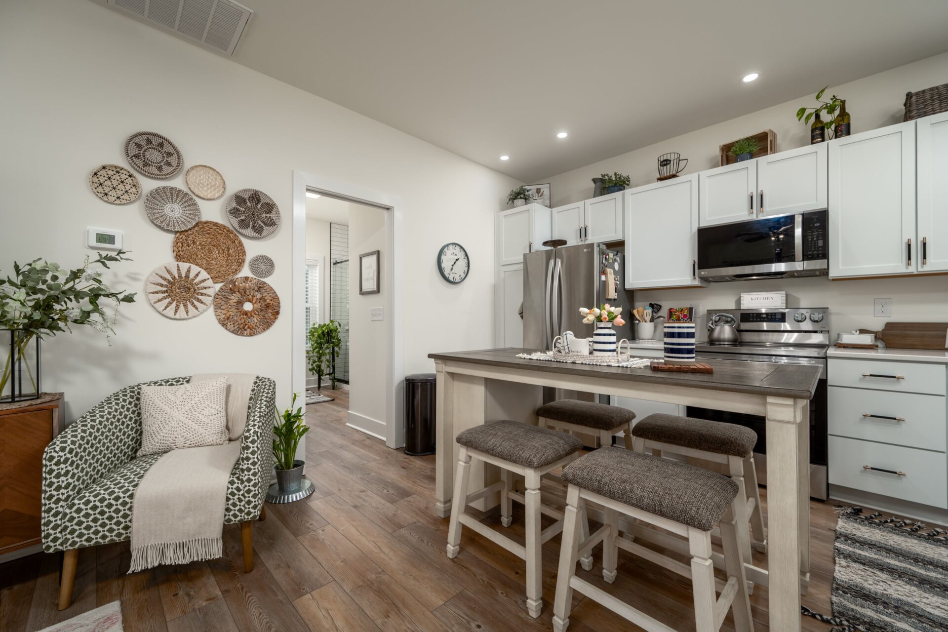 a kitchen with white cabinets and a center island
