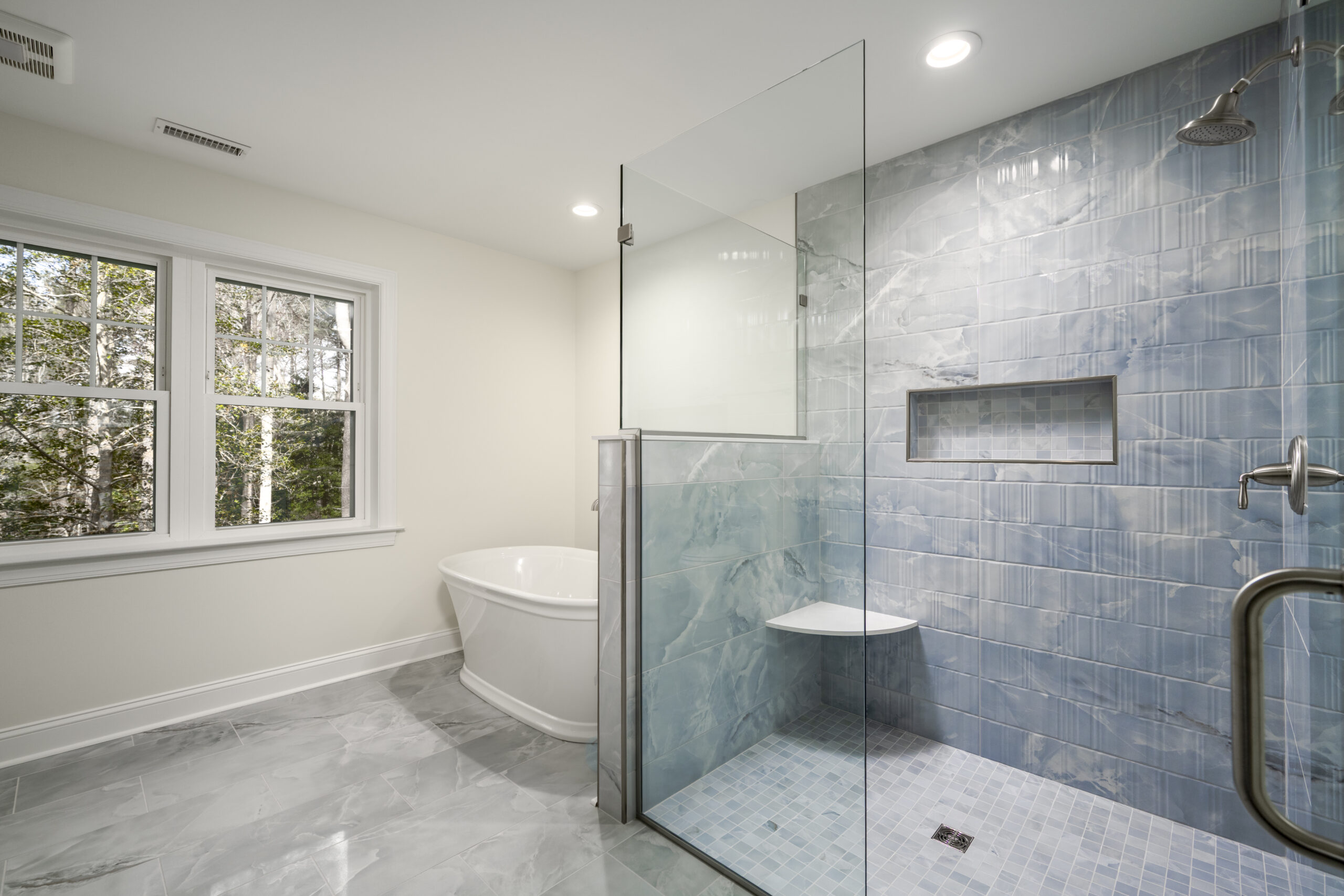 a bathroom with a walk in shower next to a toilet