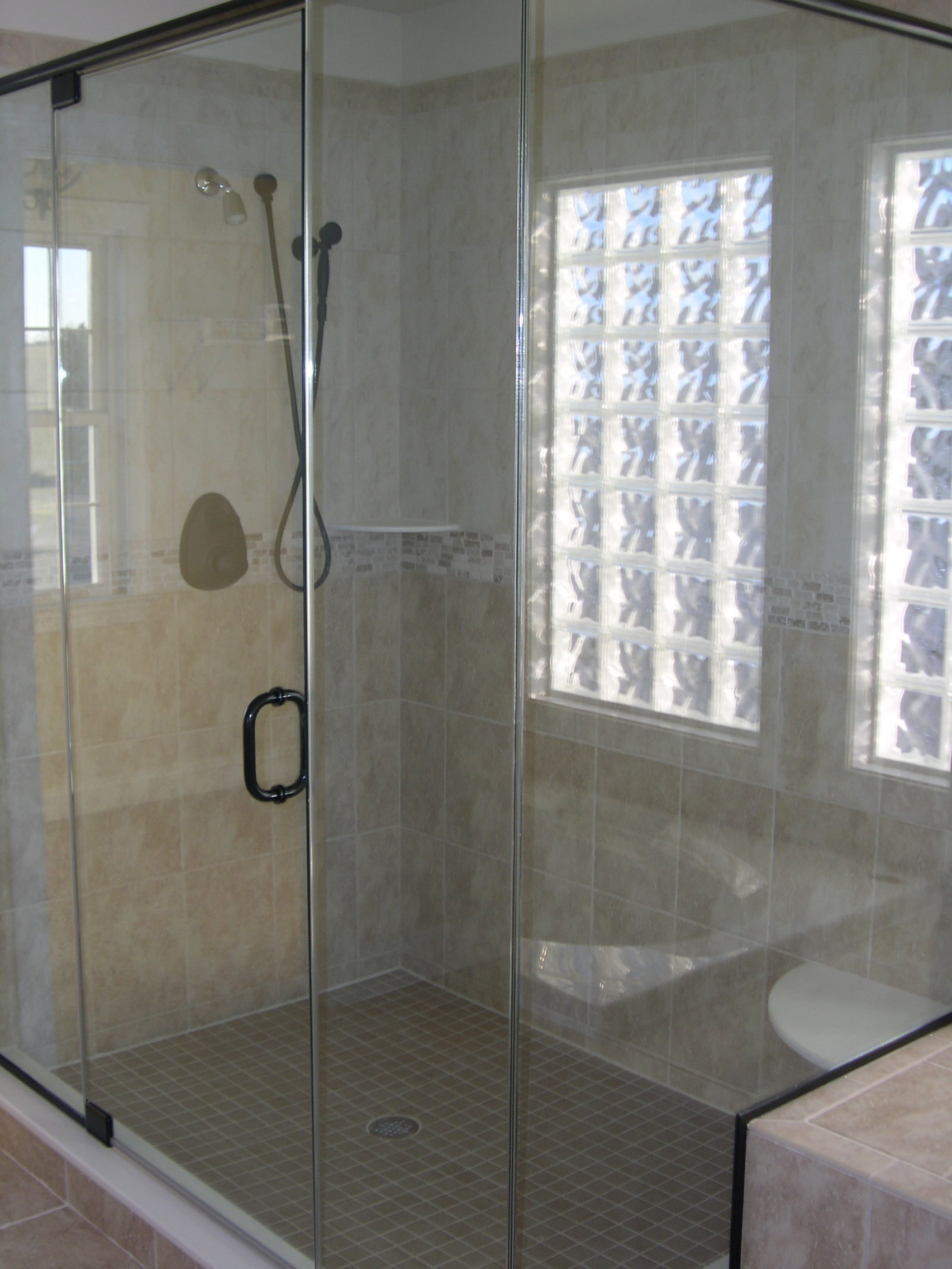 a bathroom with a walk in shower next to a toilet