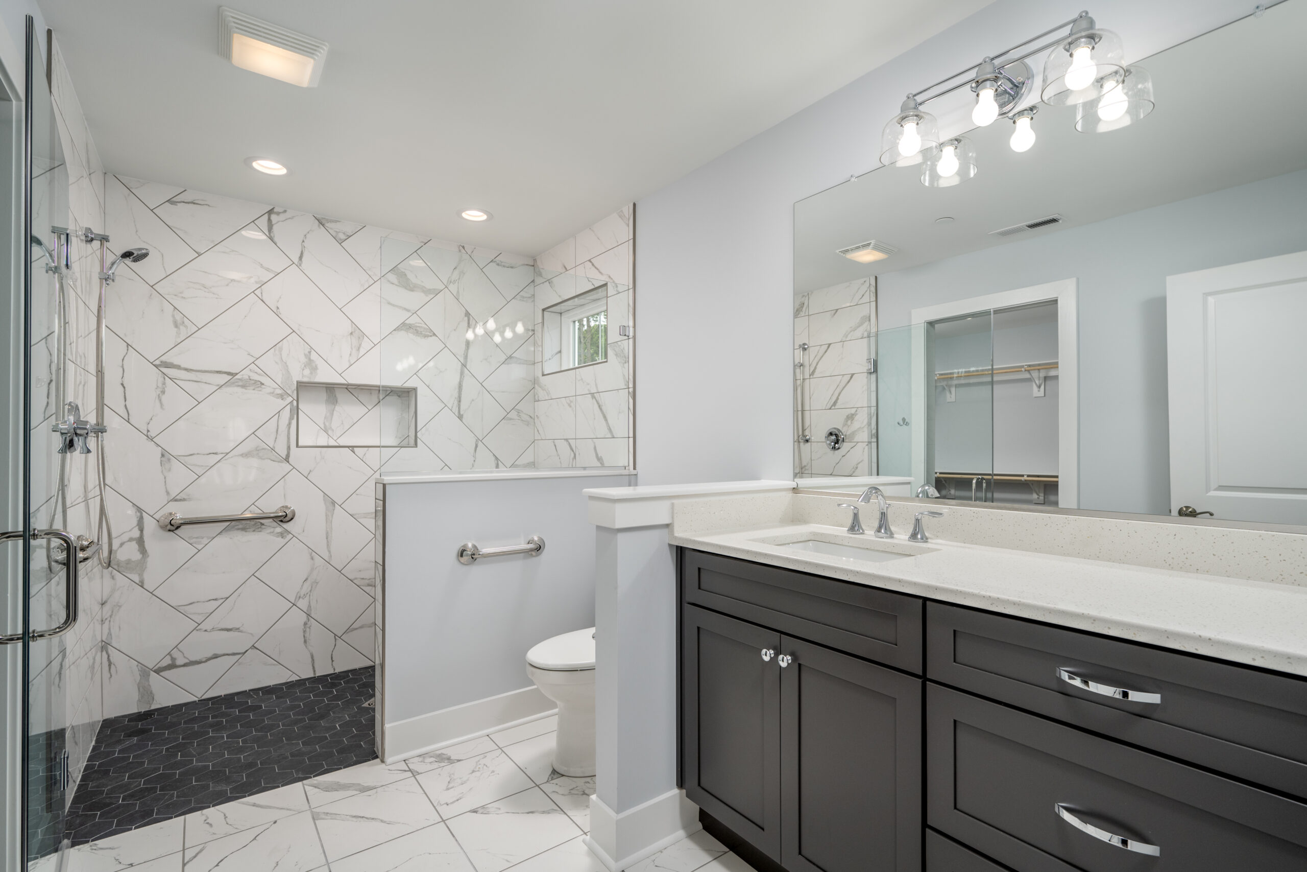 a bathroom with a walk in shower next to a toilet