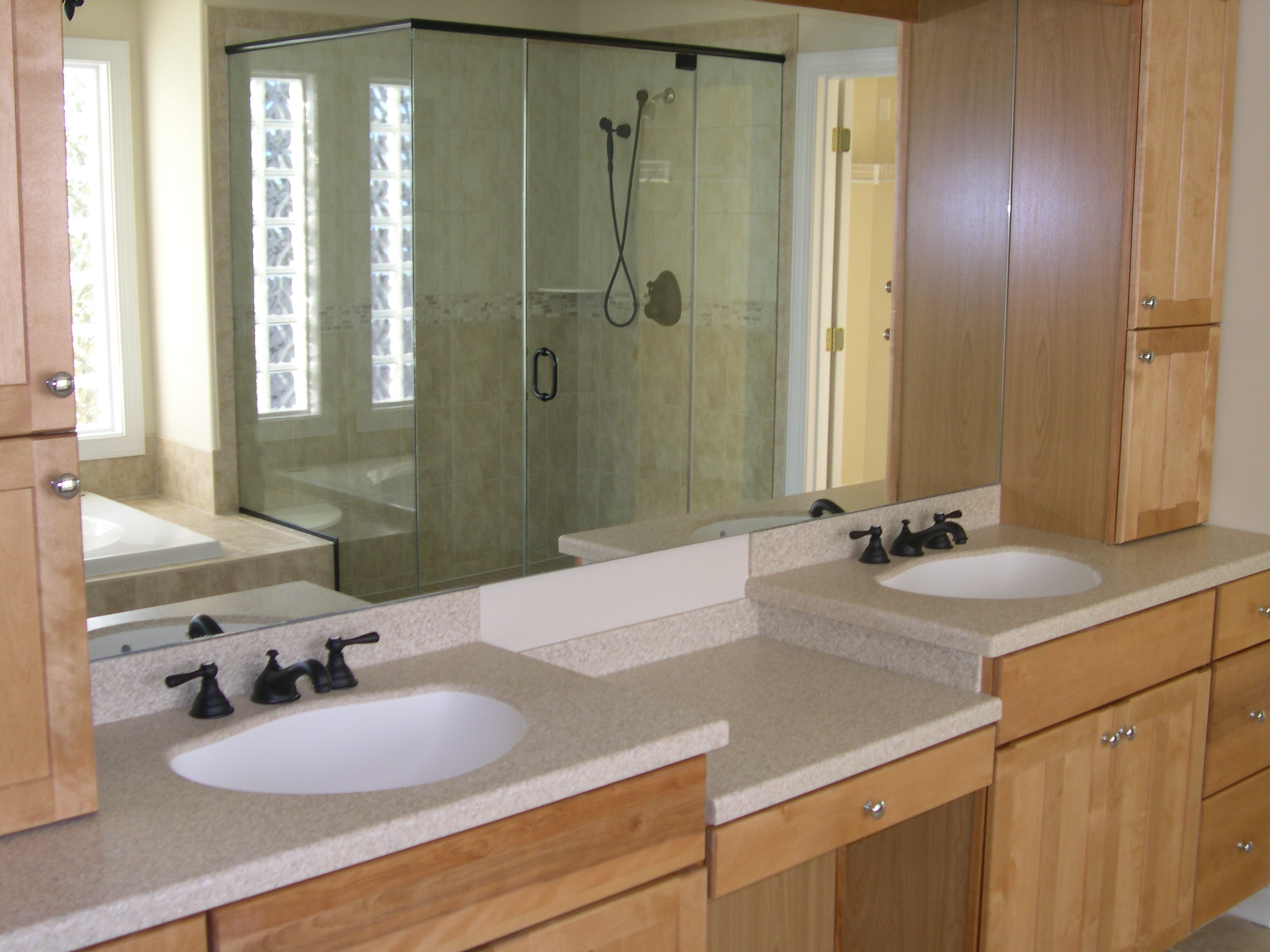 a bathroom with two sinks and a shower