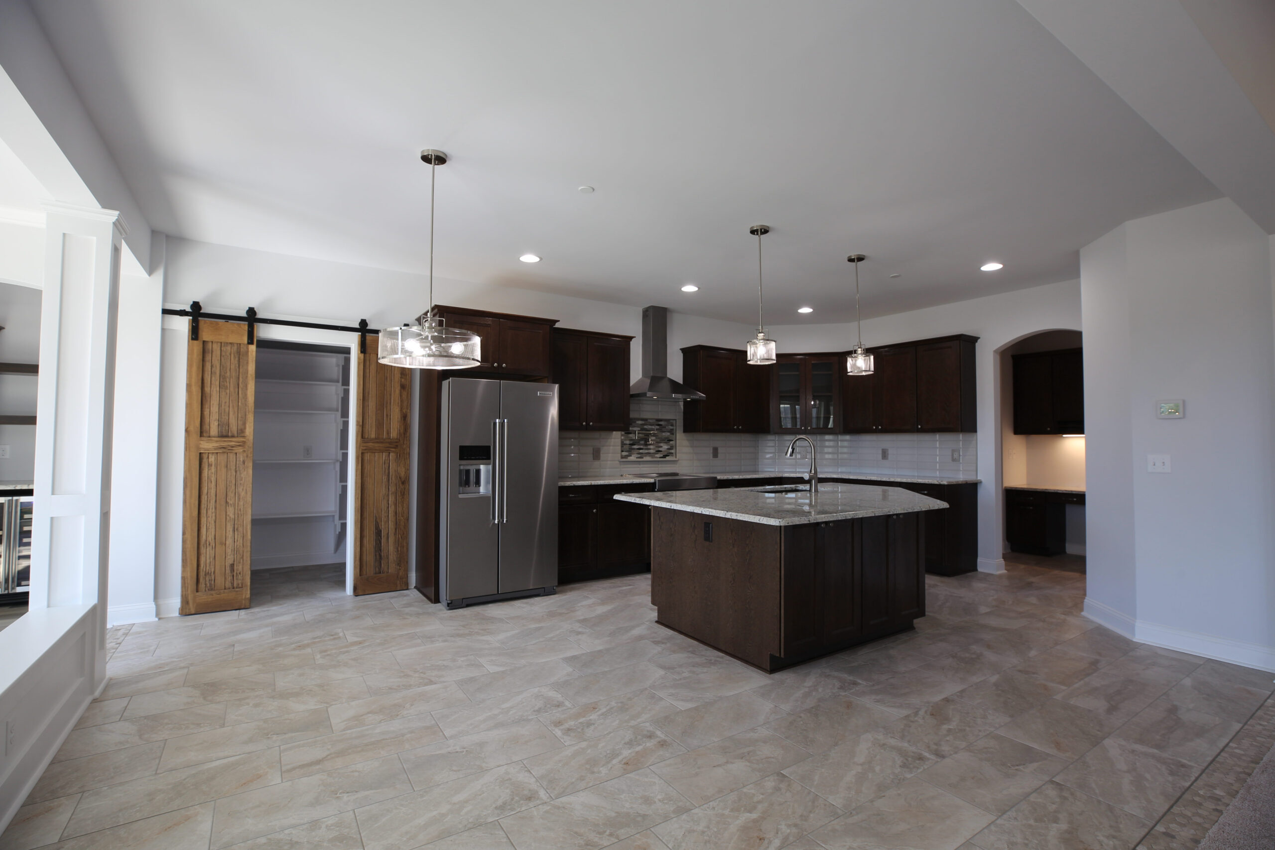a large kitchen with a center island in the middle of the room