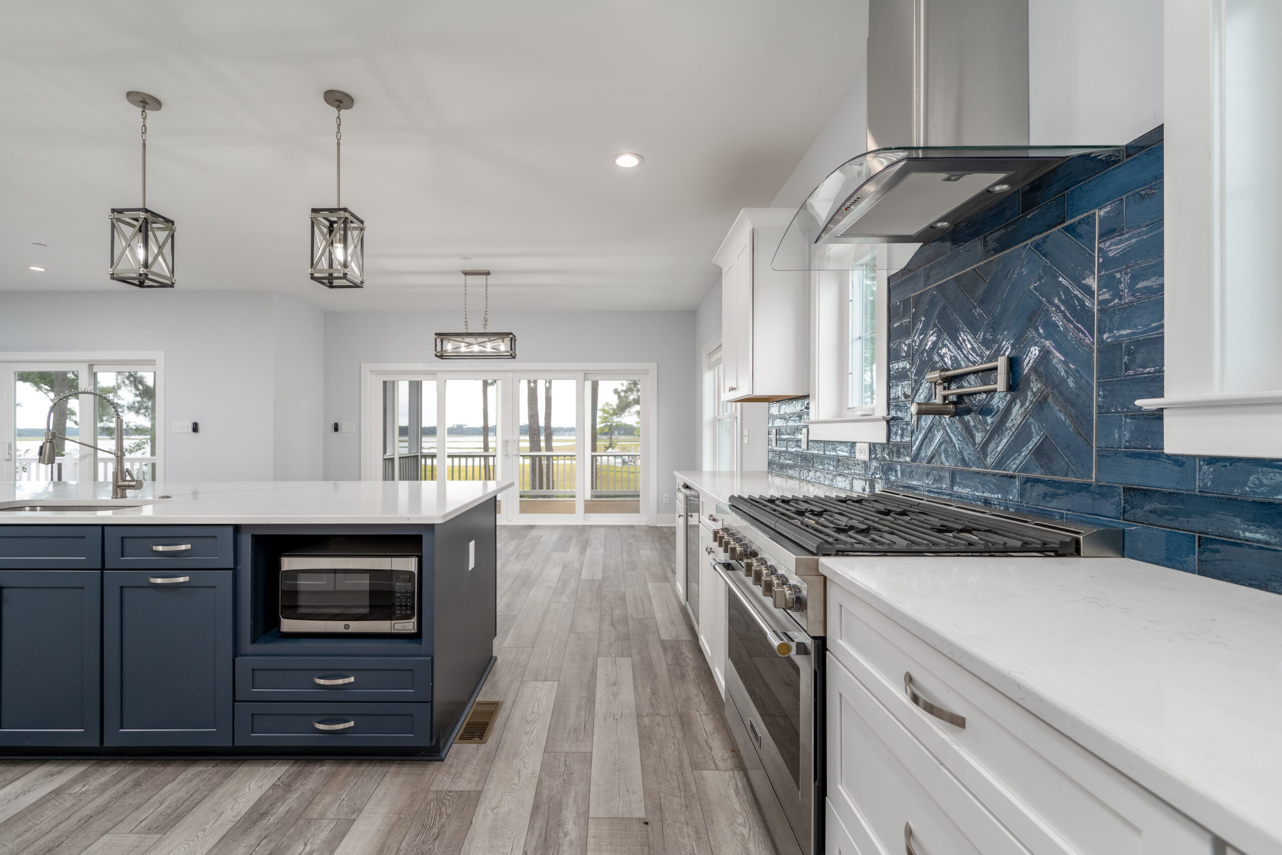 a large kitchen with a center island and a stove top oven