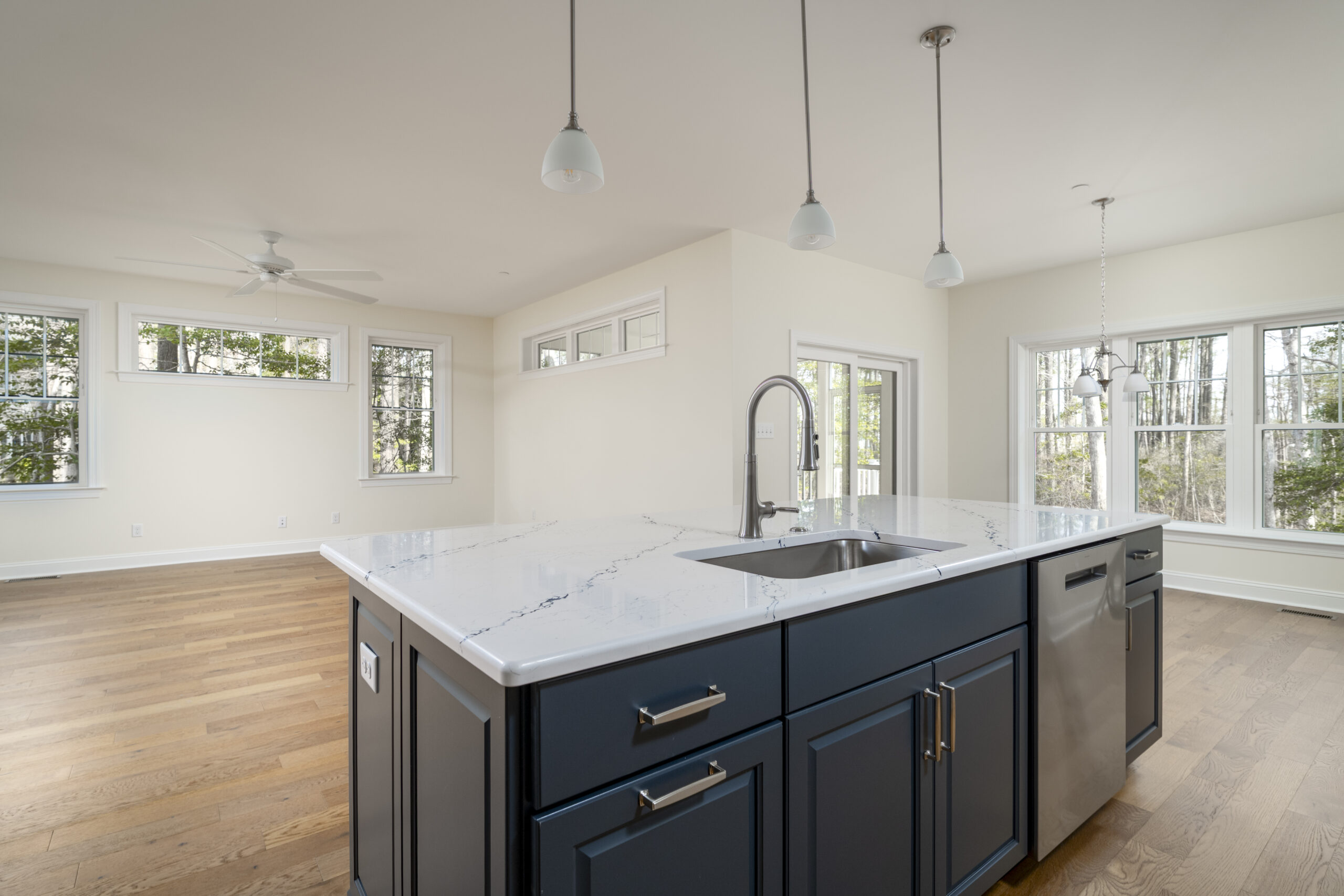 a large kitchen with a center island in the middle of the room