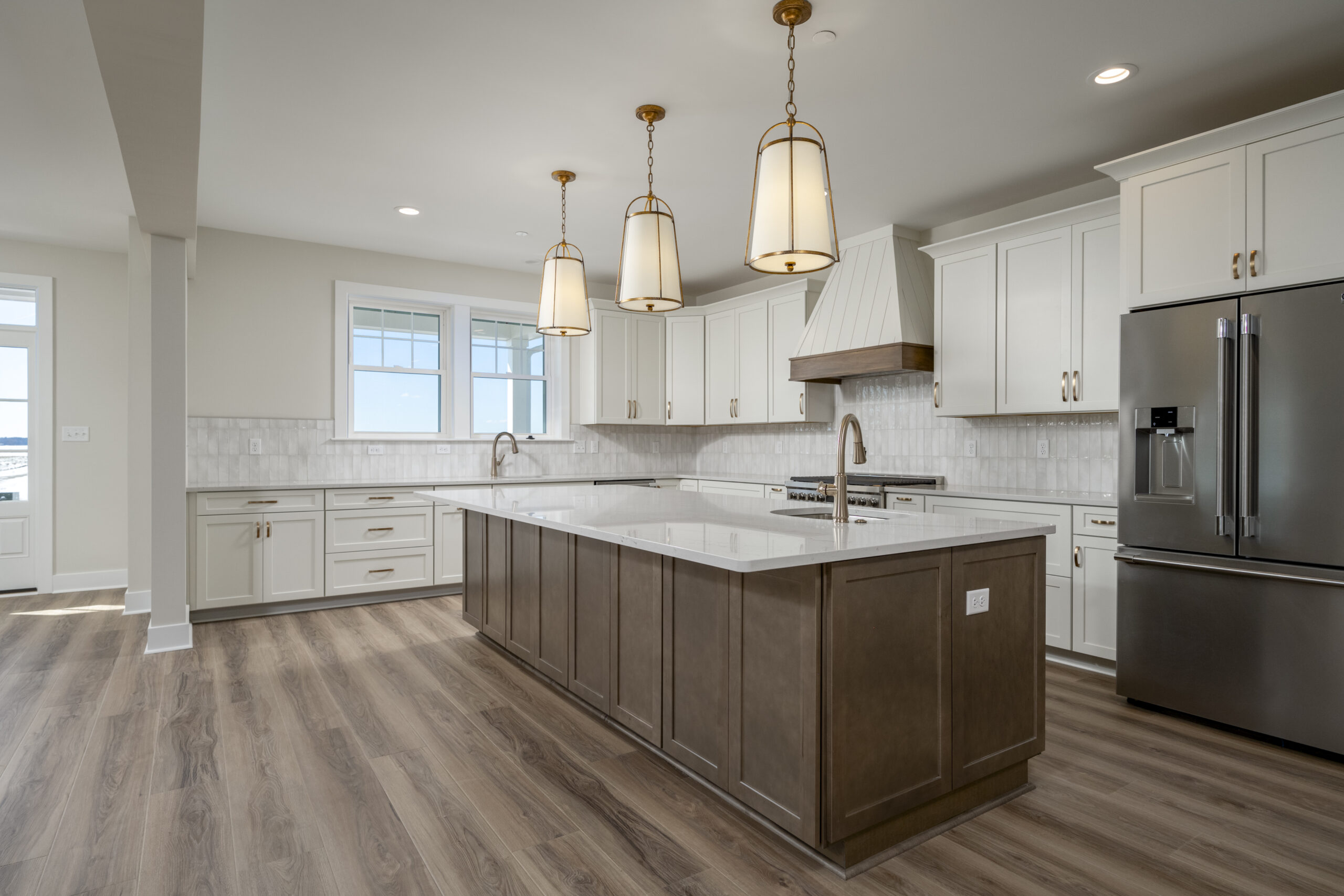 a large kitchen with a center island in the middle of the room