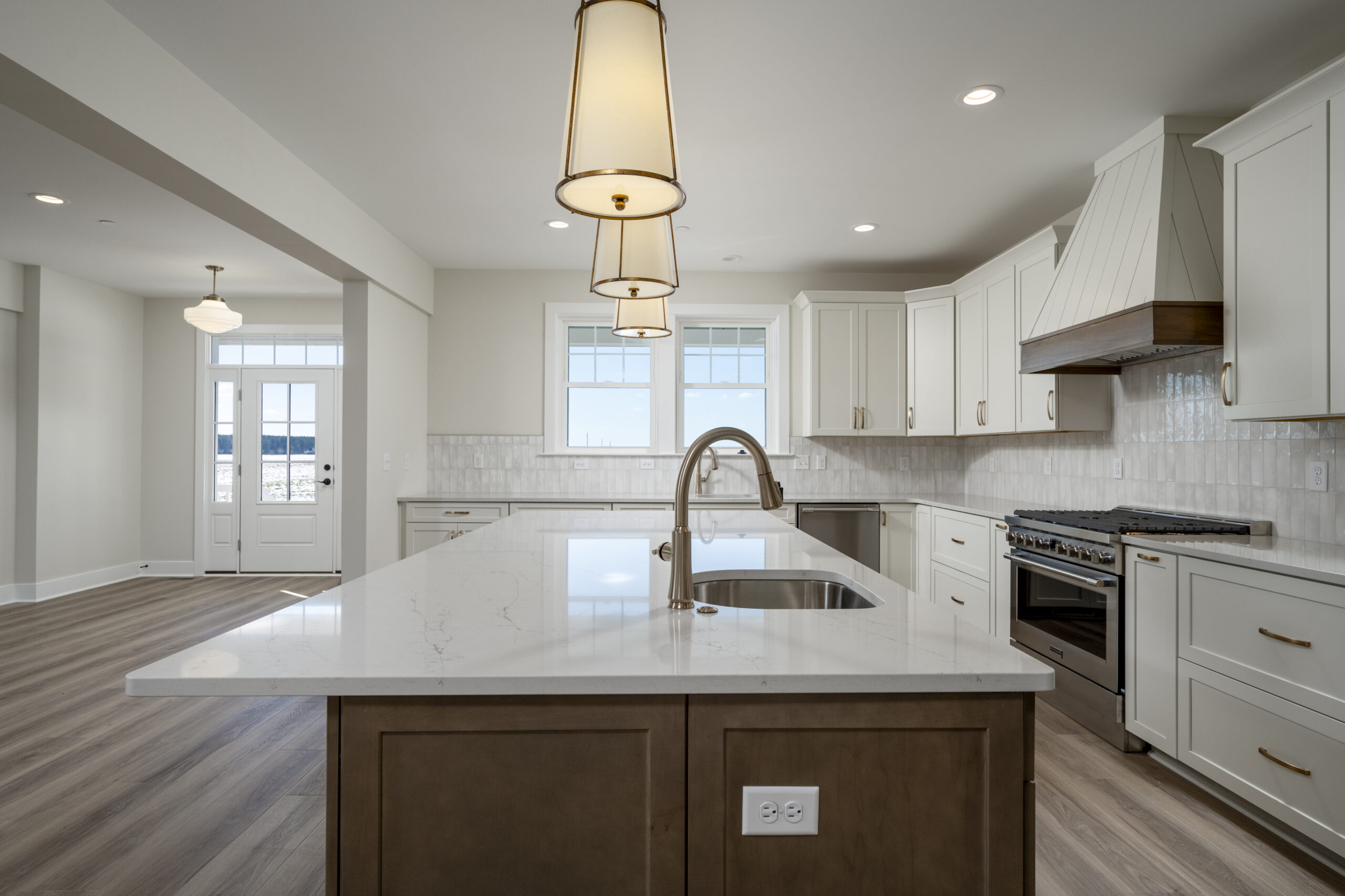 a large kitchen with a center island in the middle of the room