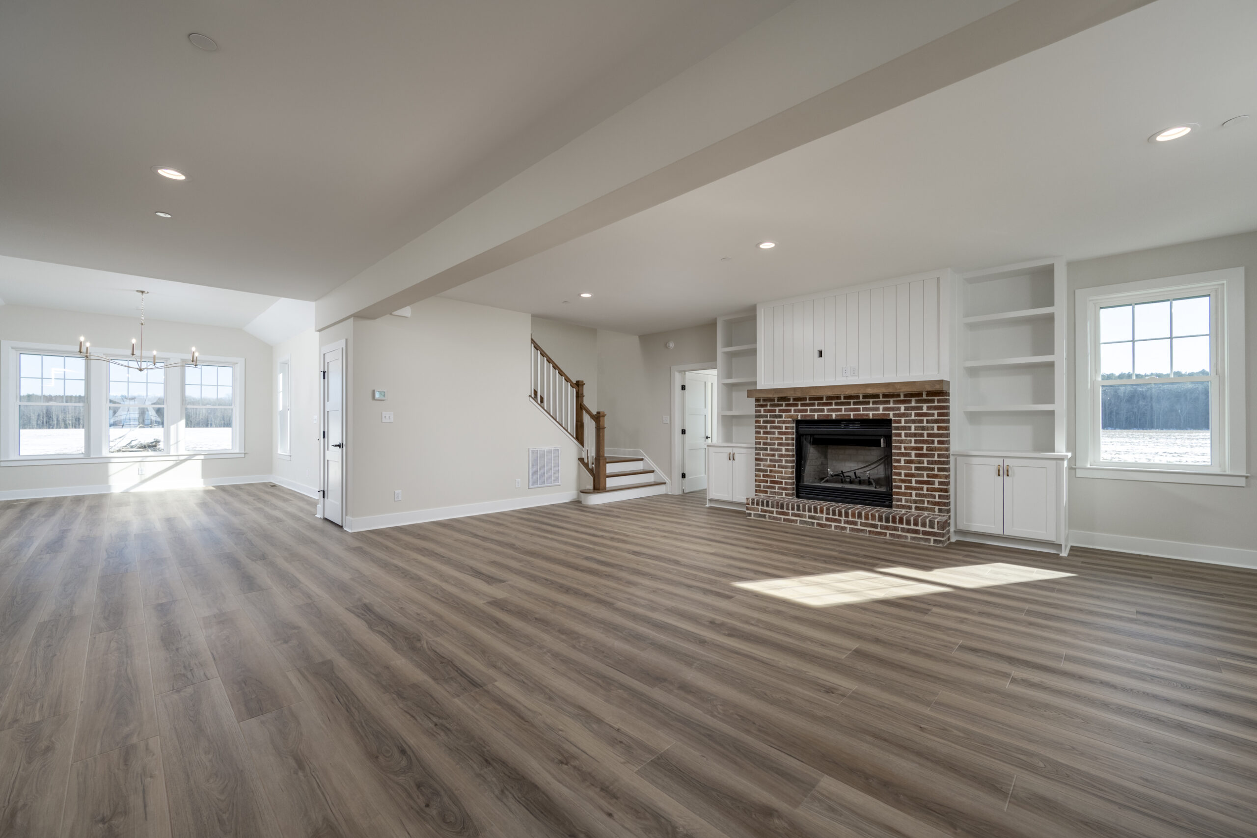 a large empty living room with a fireplace