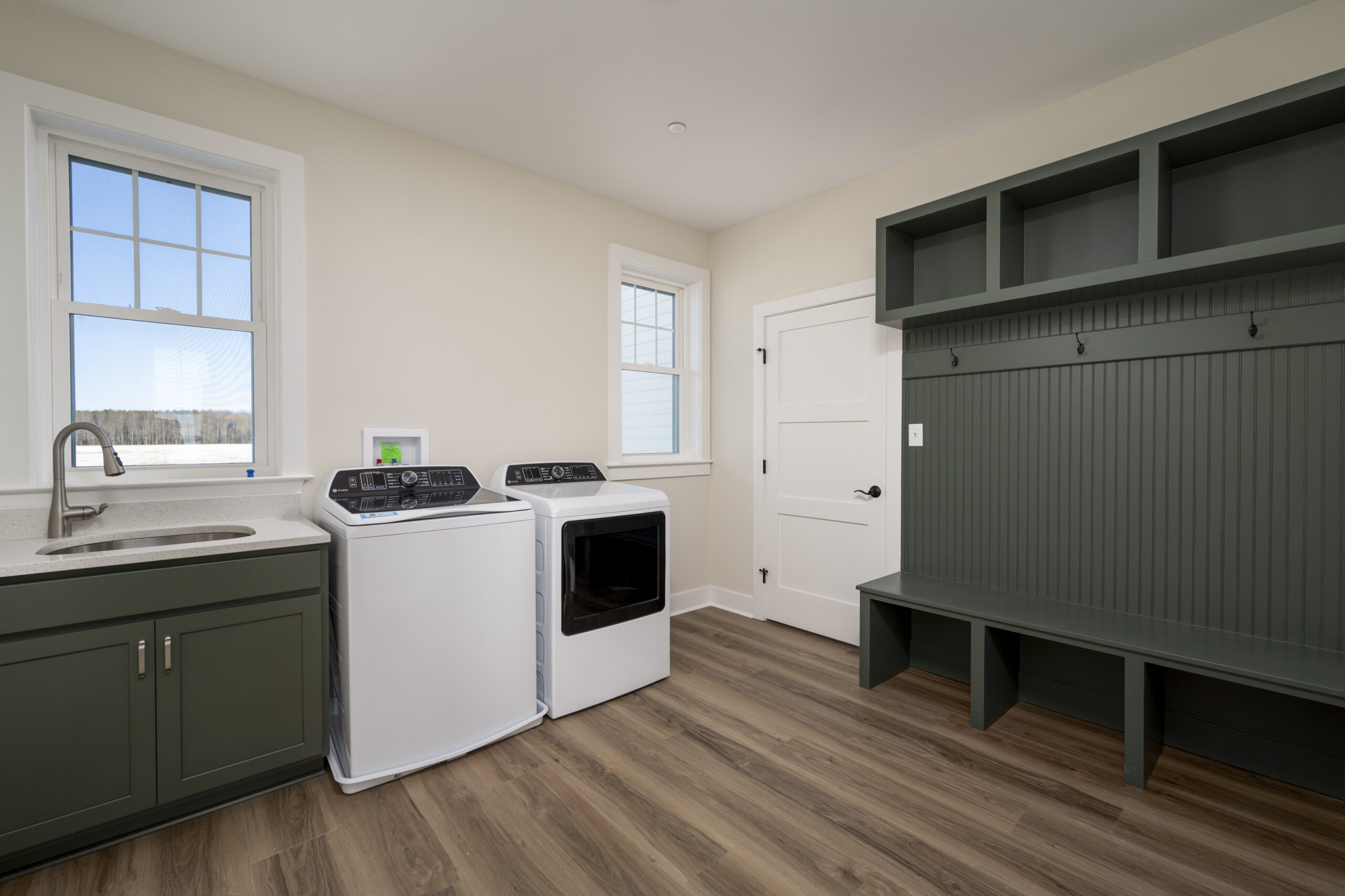 a kitchen with a stove top oven next to a washer and dryer