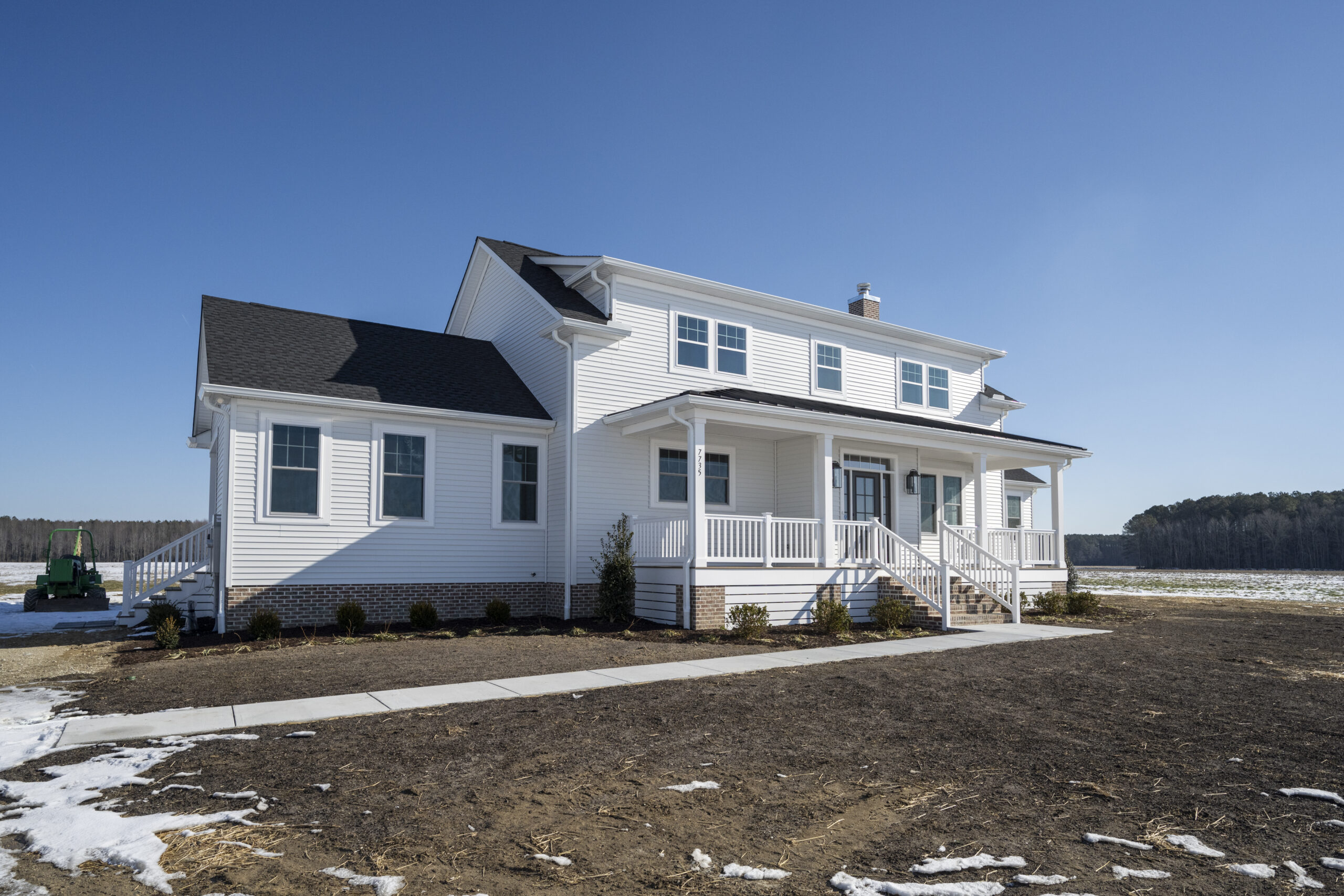 a white house with a black roof and white trim