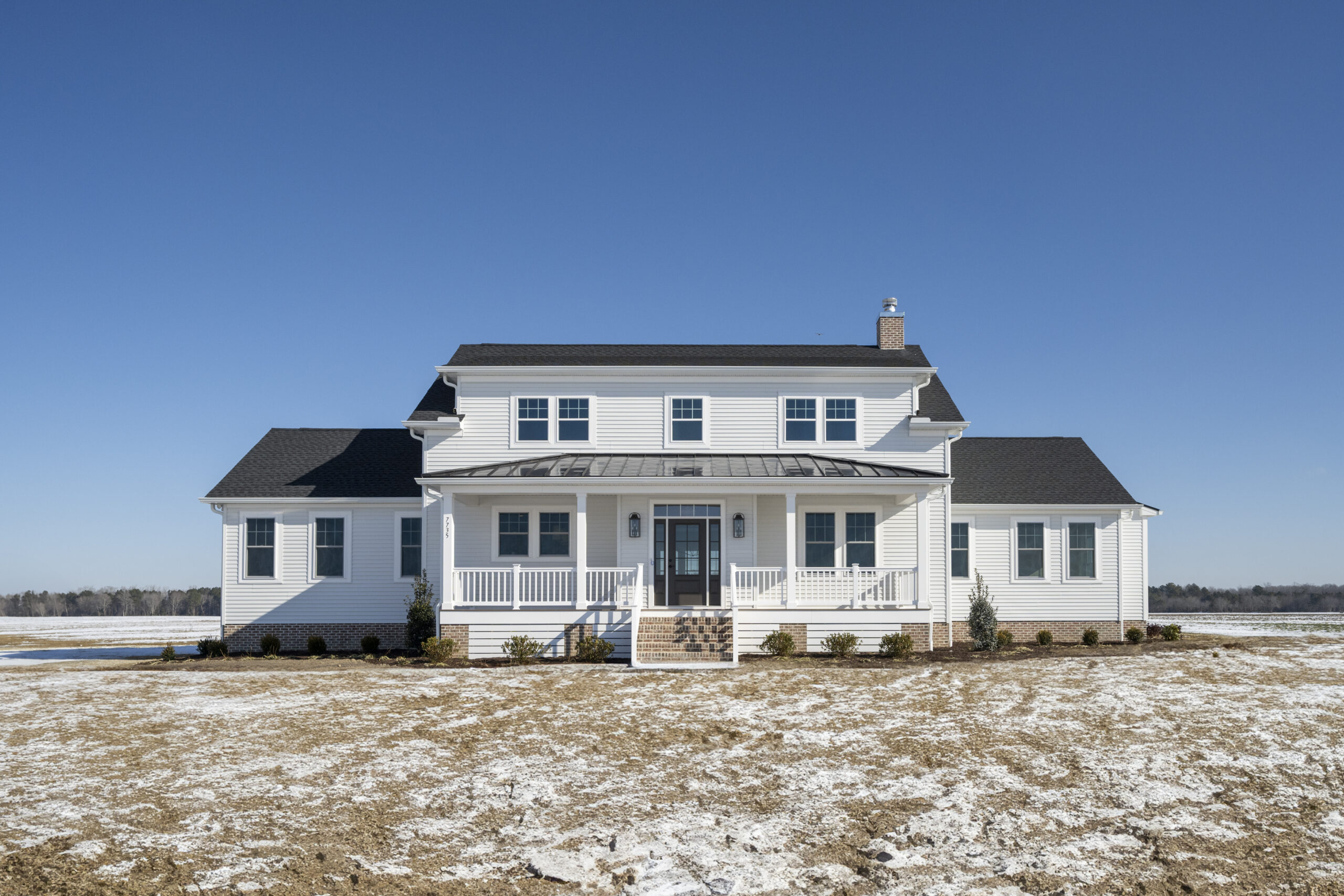 a large white house with a black roof