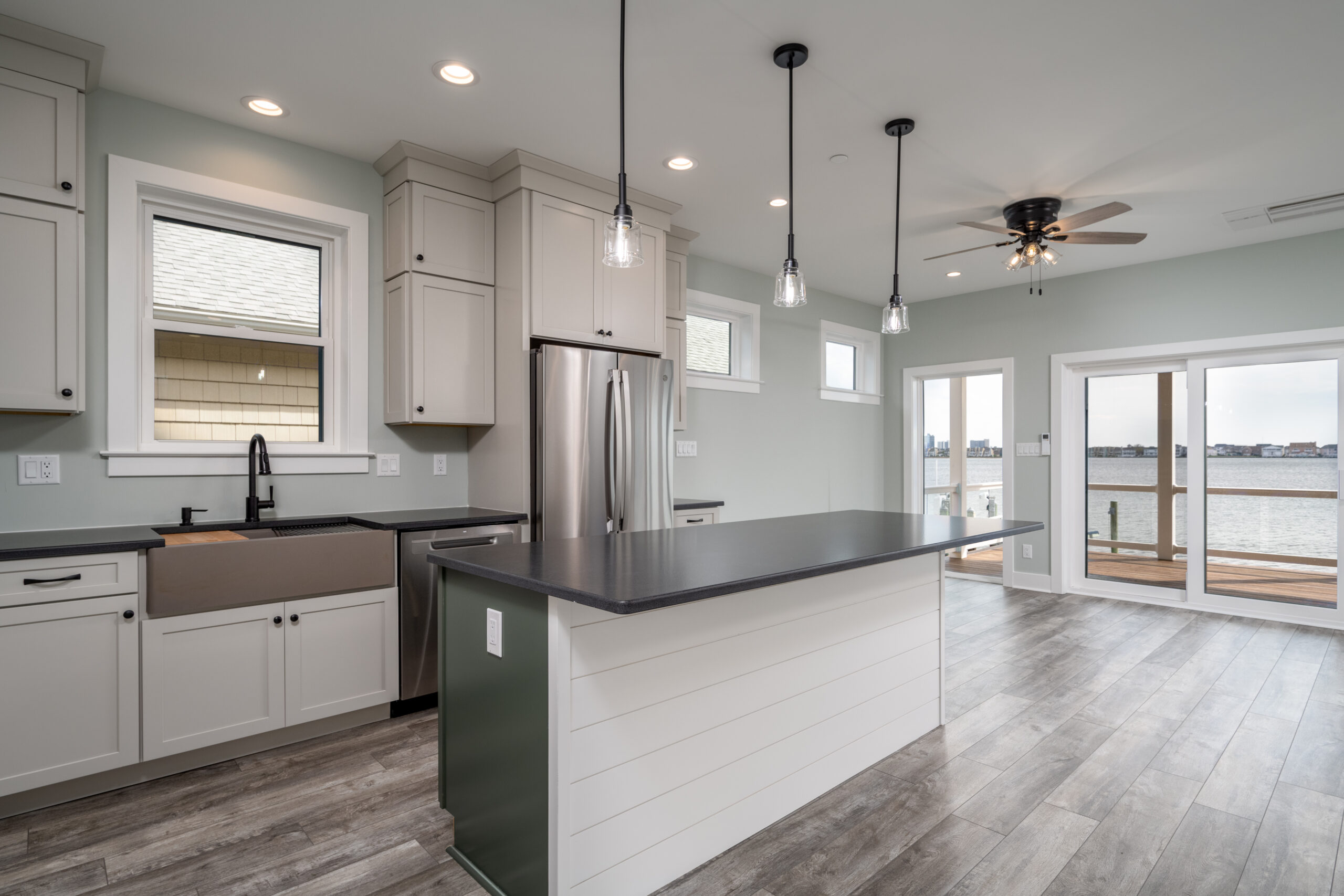 a large kitchen with a center island in the middle of the room