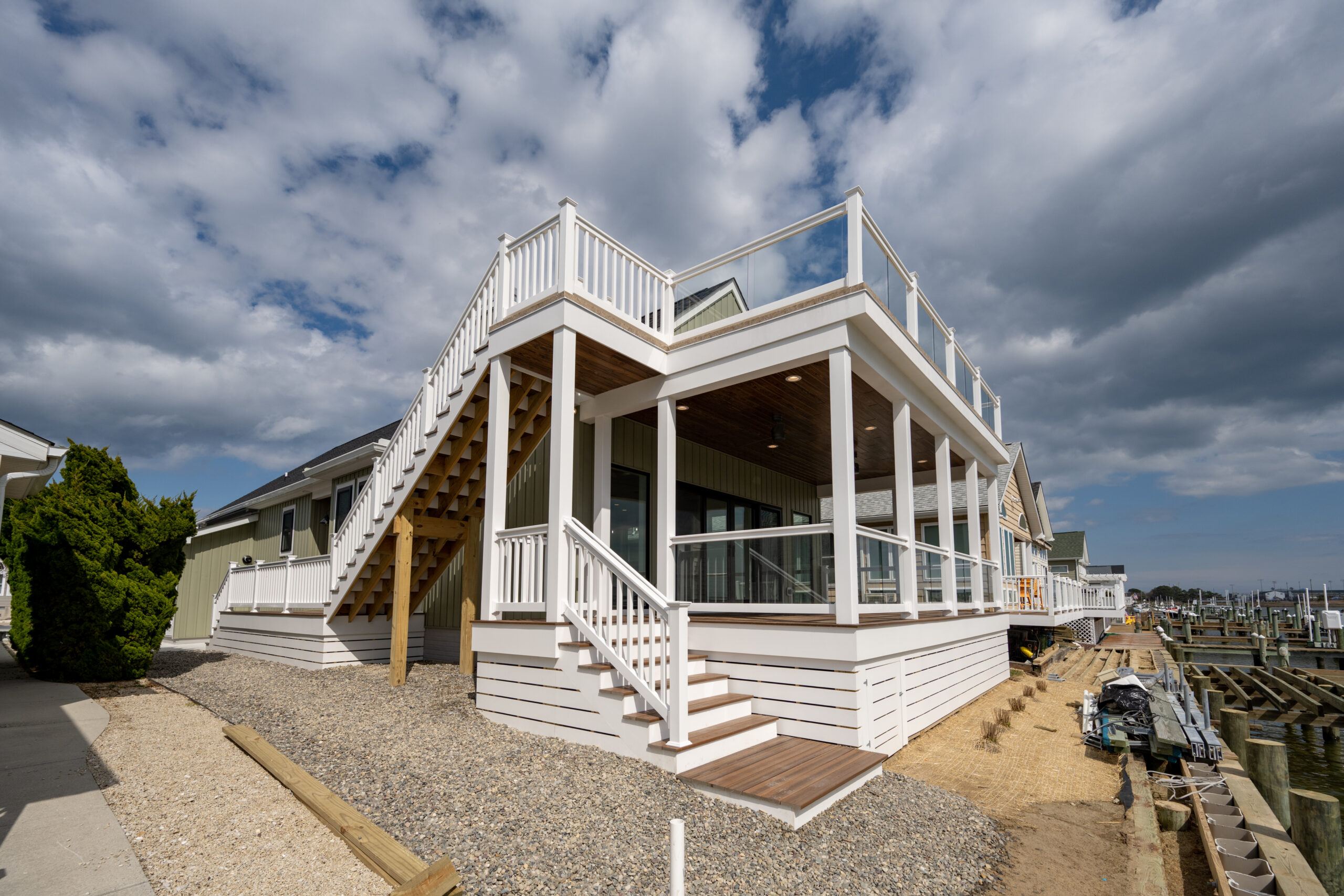 a large white house sitting on top of a sandy beach
