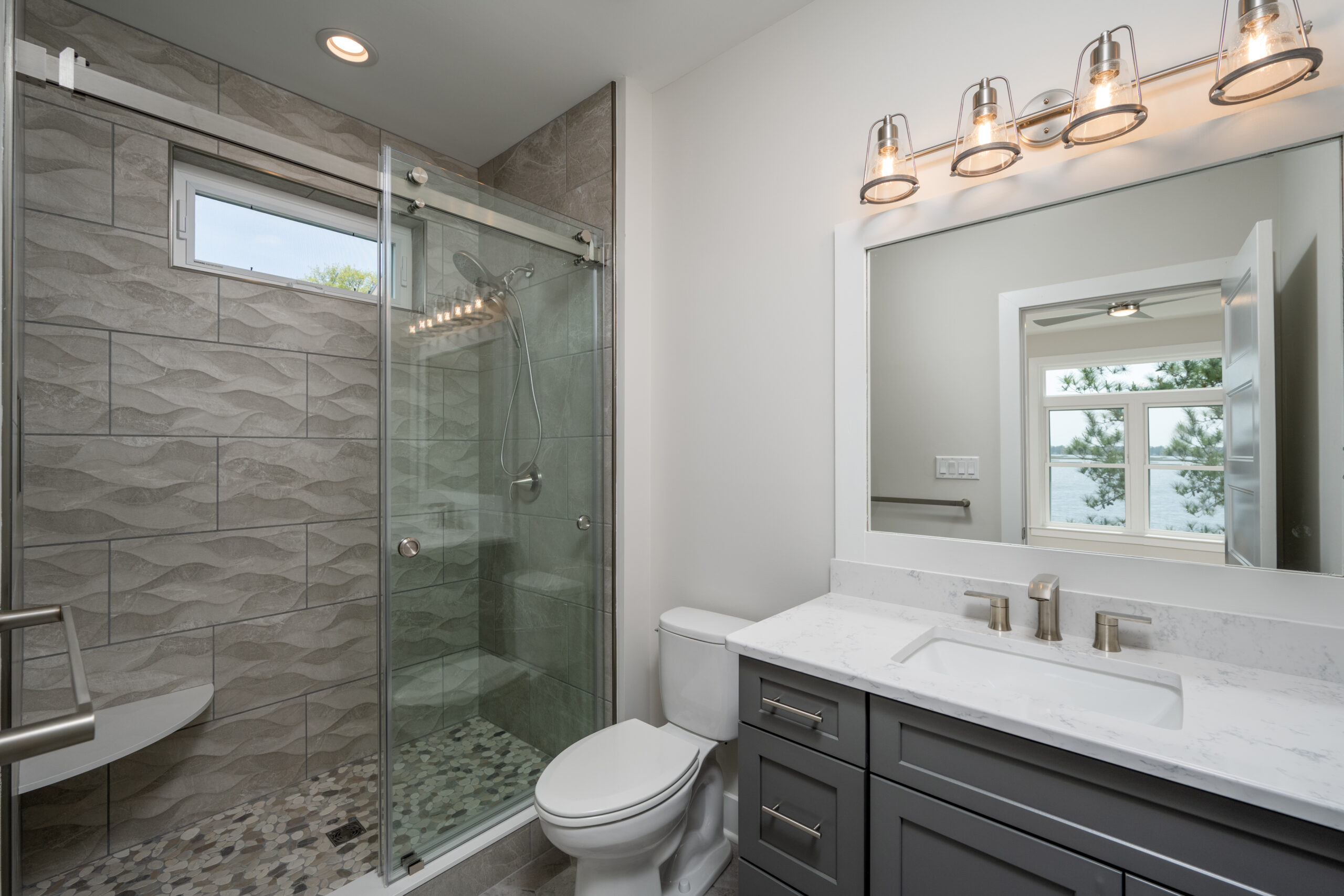 a bathroom with a walk in shower next to a toilet