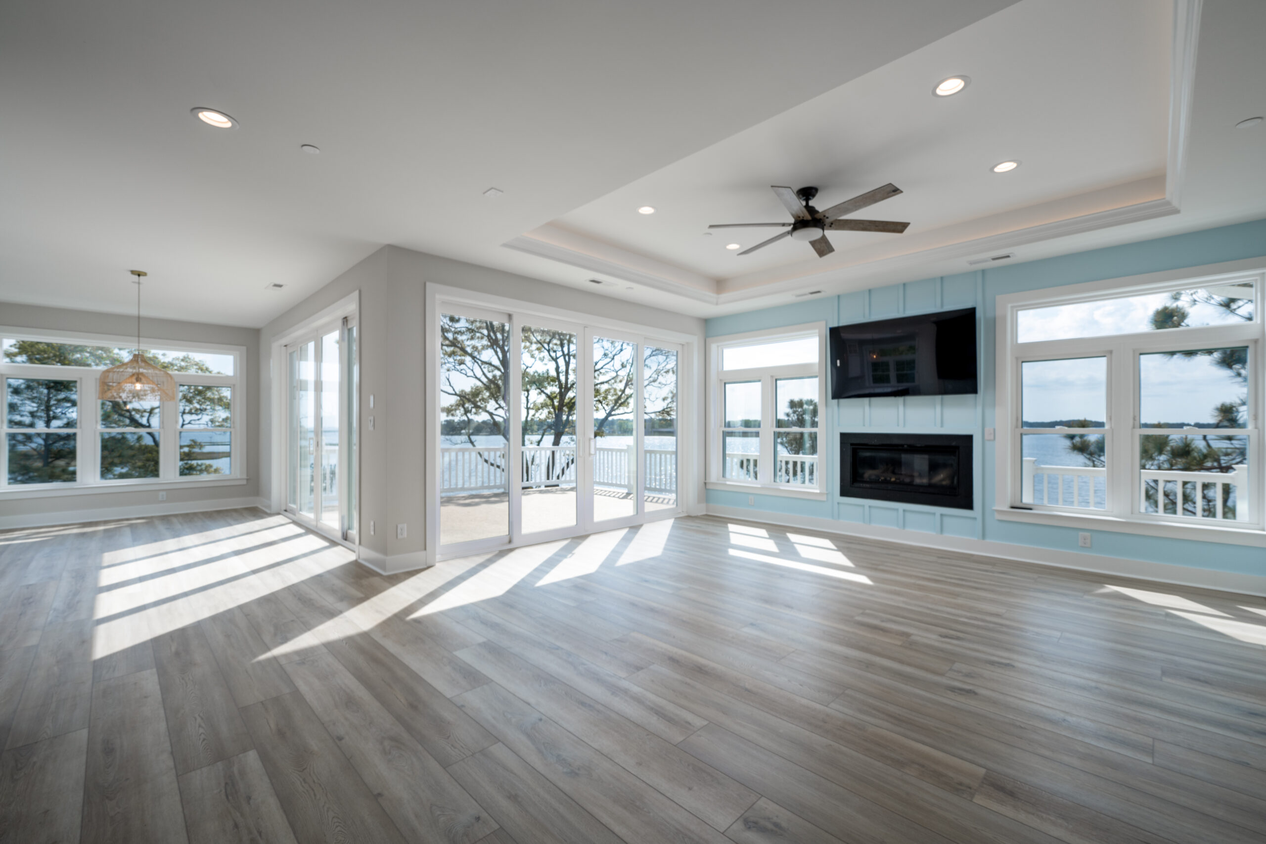a large empty room with a ceiling fan