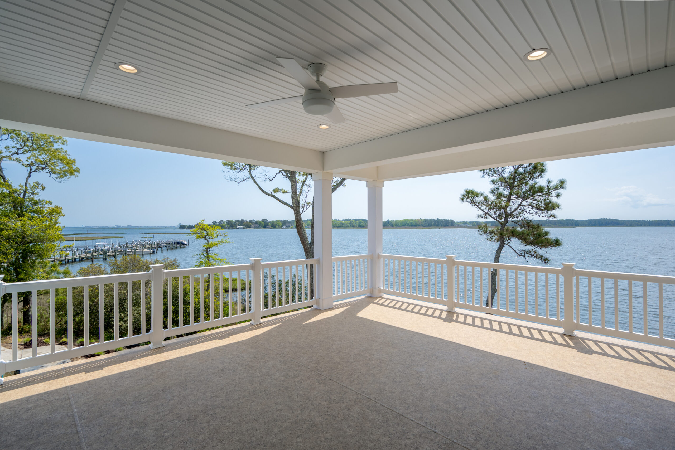 a covered porch with a view of the water