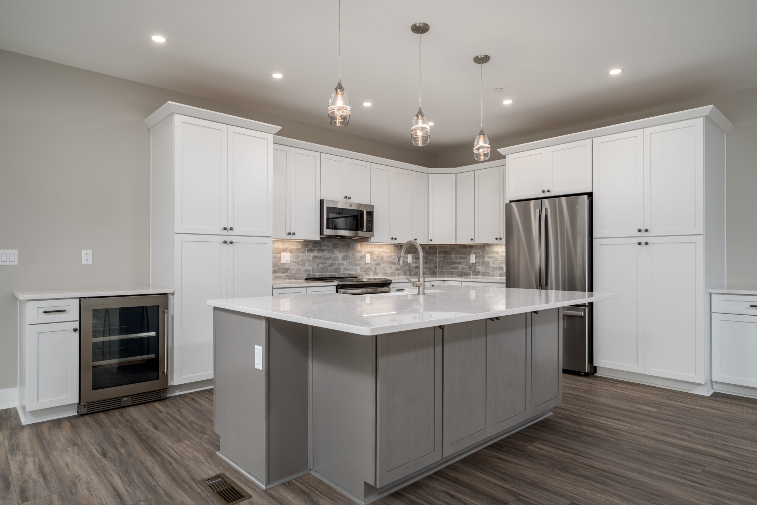 a large kitchen with a center island in the middle of the room