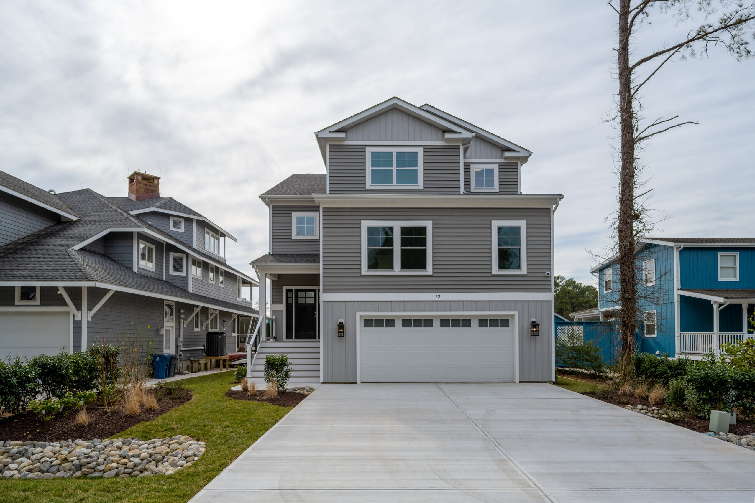 a two story house with a driveway in front of it