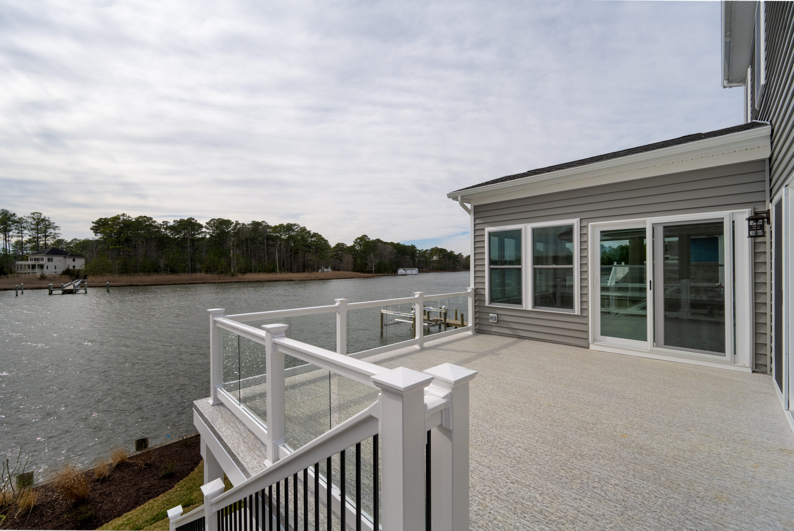 a balcony with a railing and a view of the water