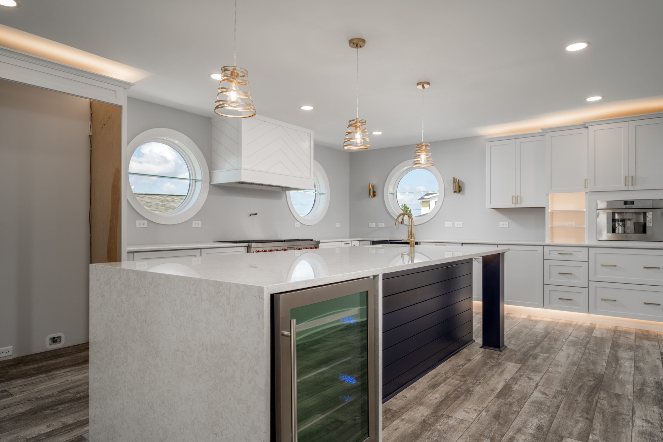 a large kitchen with a center island in the middle of the room