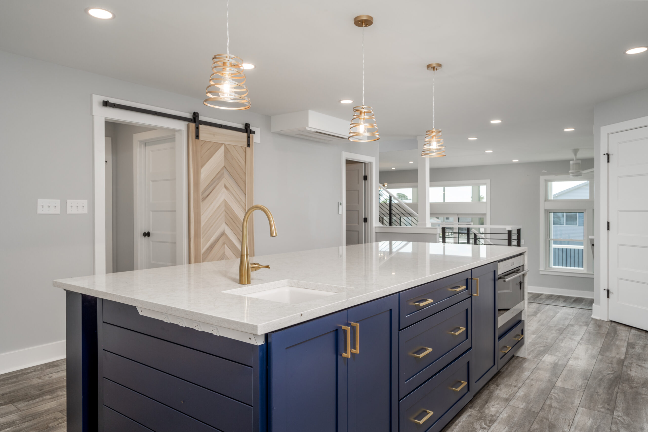 a large kitchen with a center island in the middle of the room