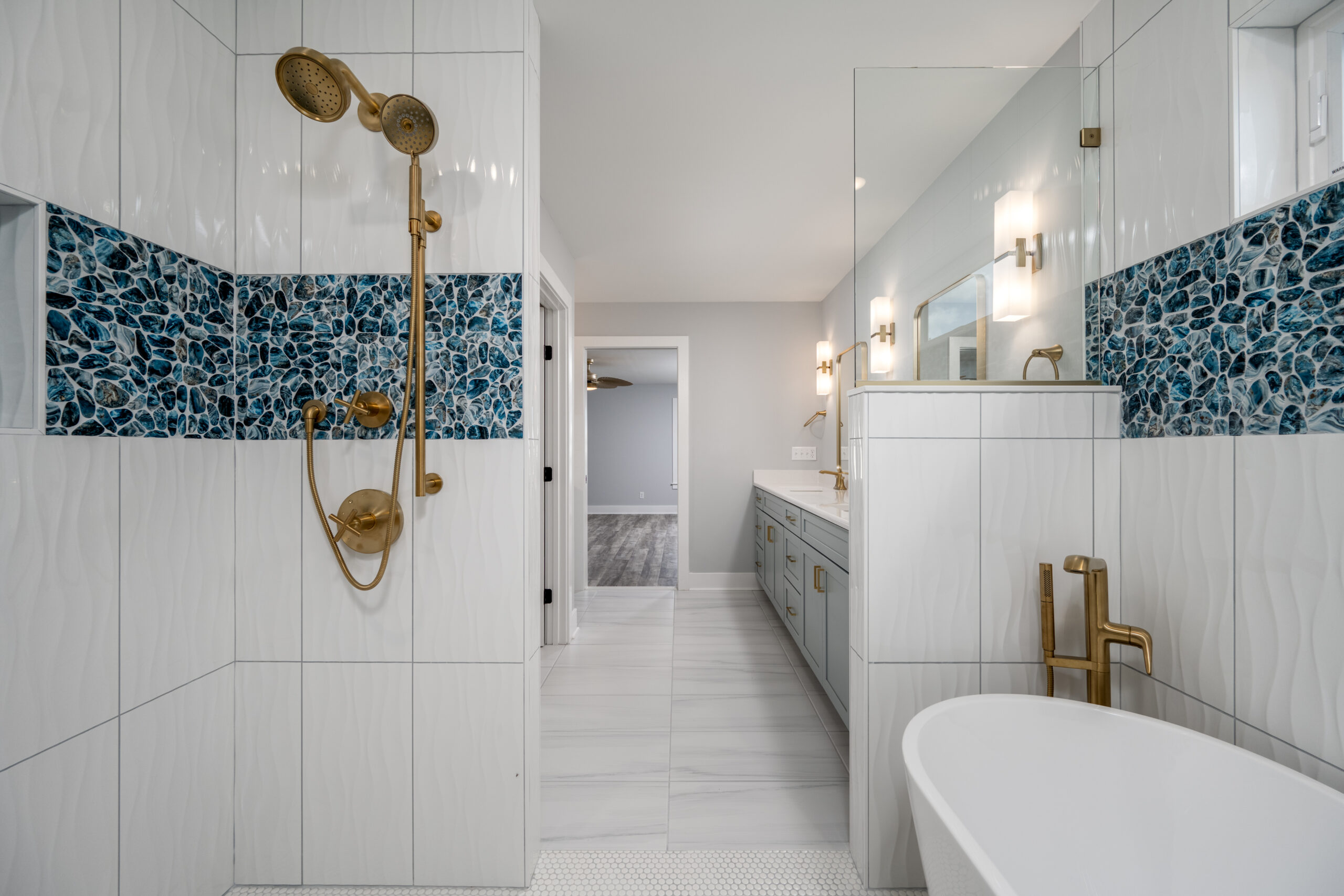 a bathroom with a bathtub, sink, and mirror