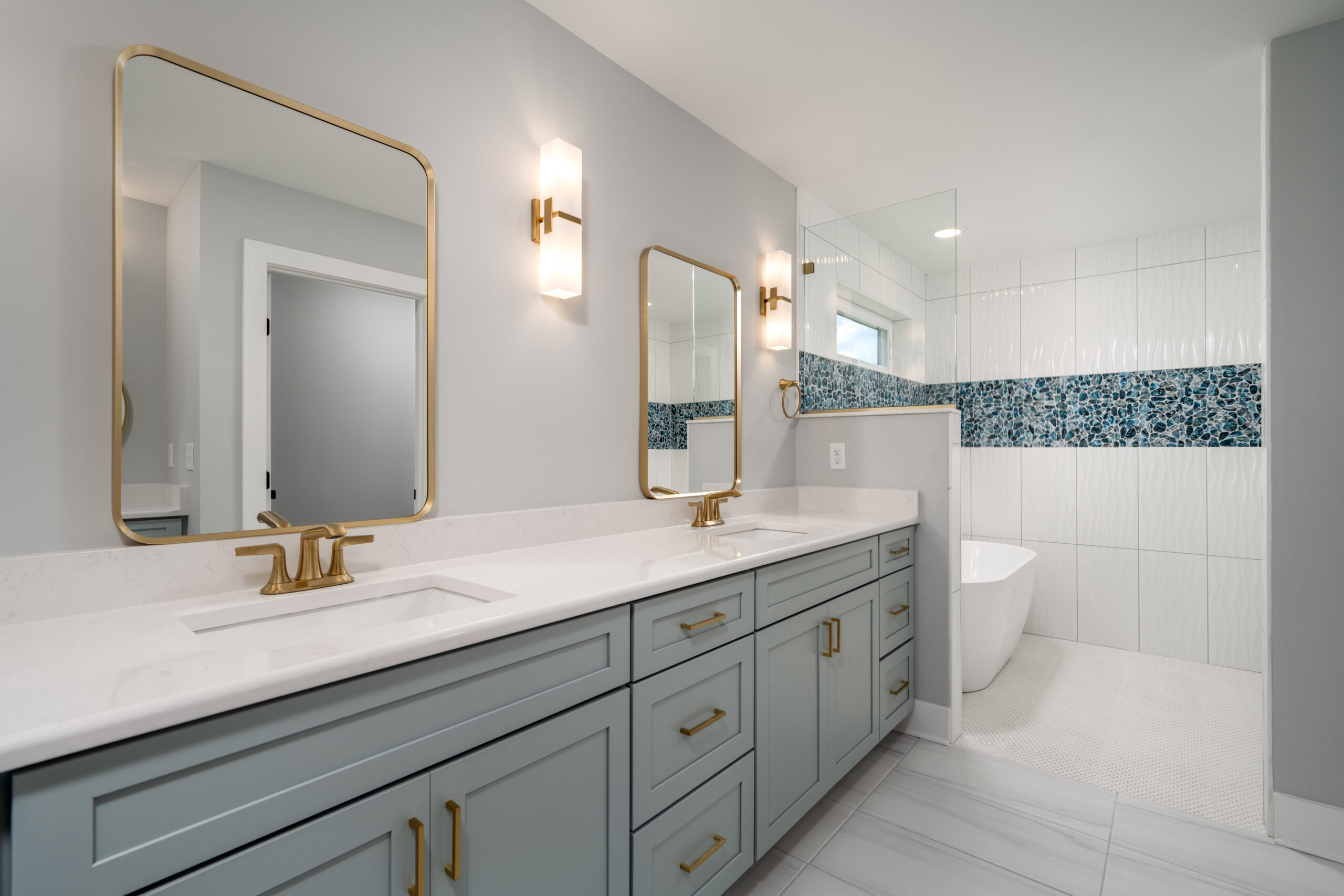 a bathroom with two sinks and a large mirror