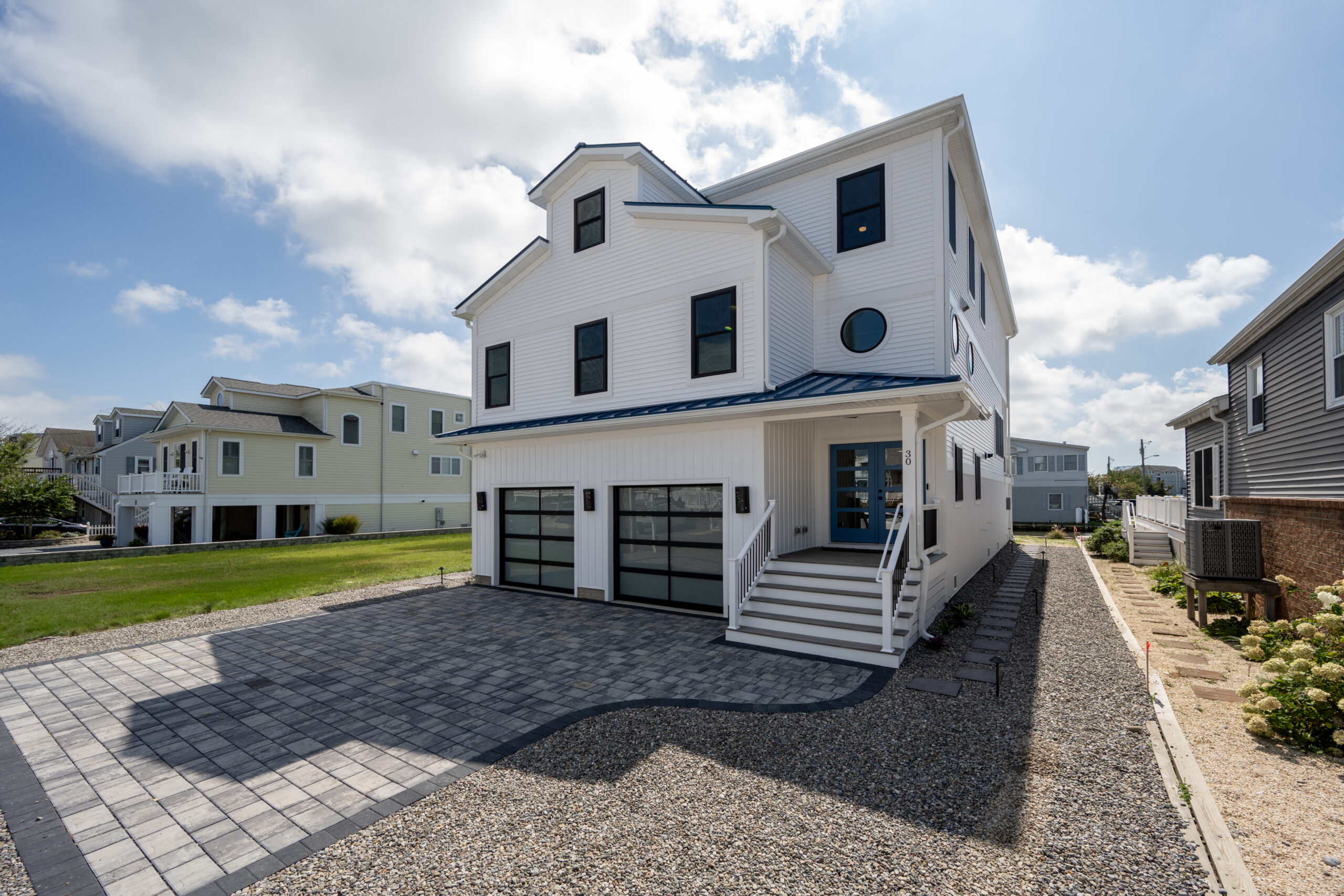 a white house with a driveway in front of it