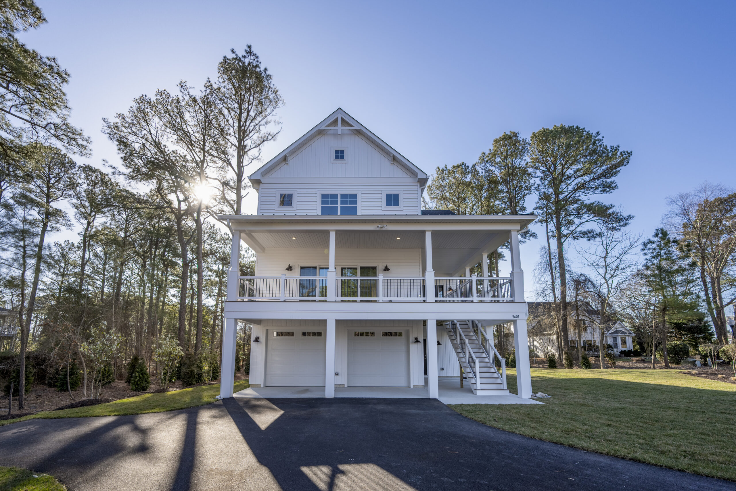 a large white house in the middle of a driveway