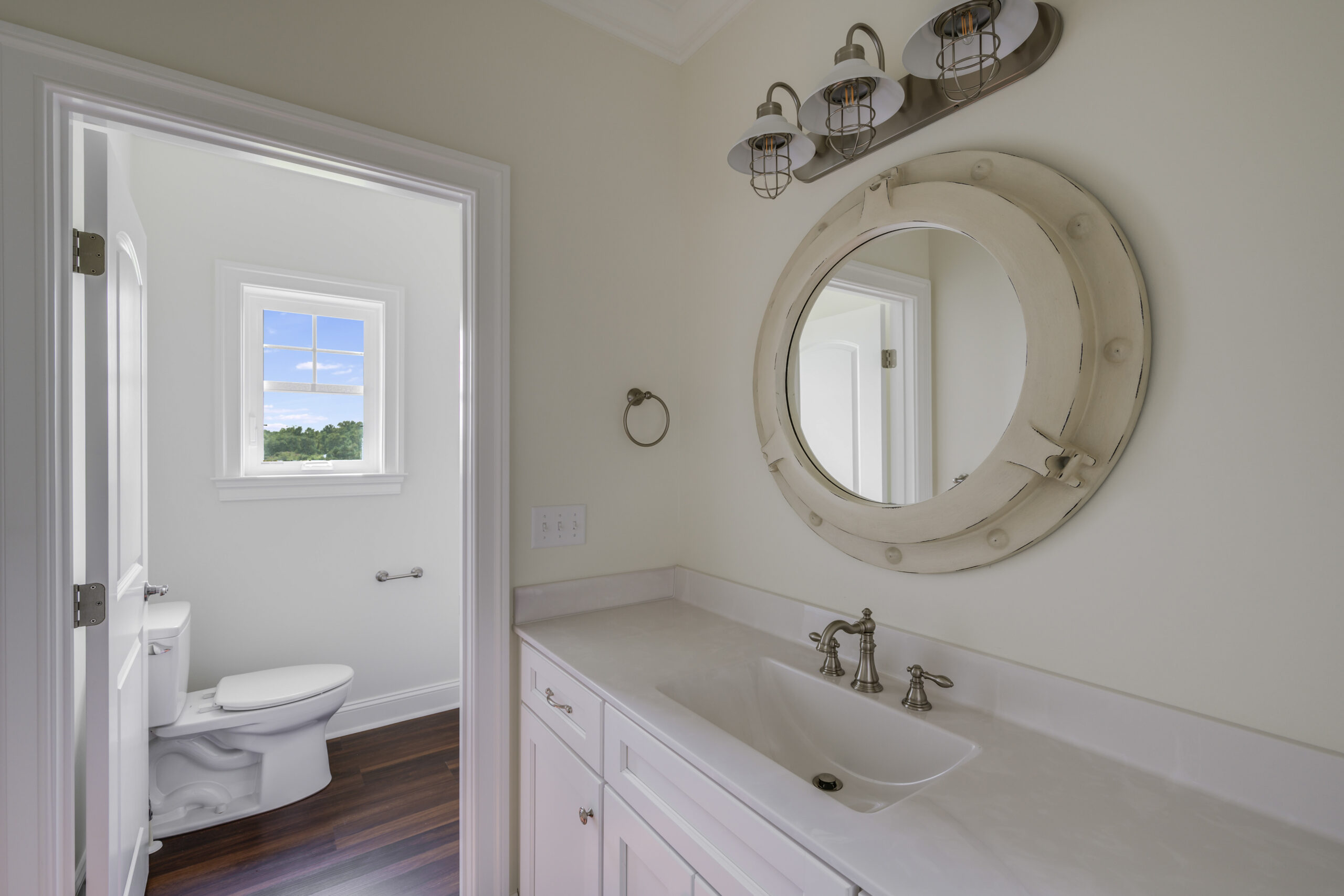 a bathroom with a sink, mirror and toilet