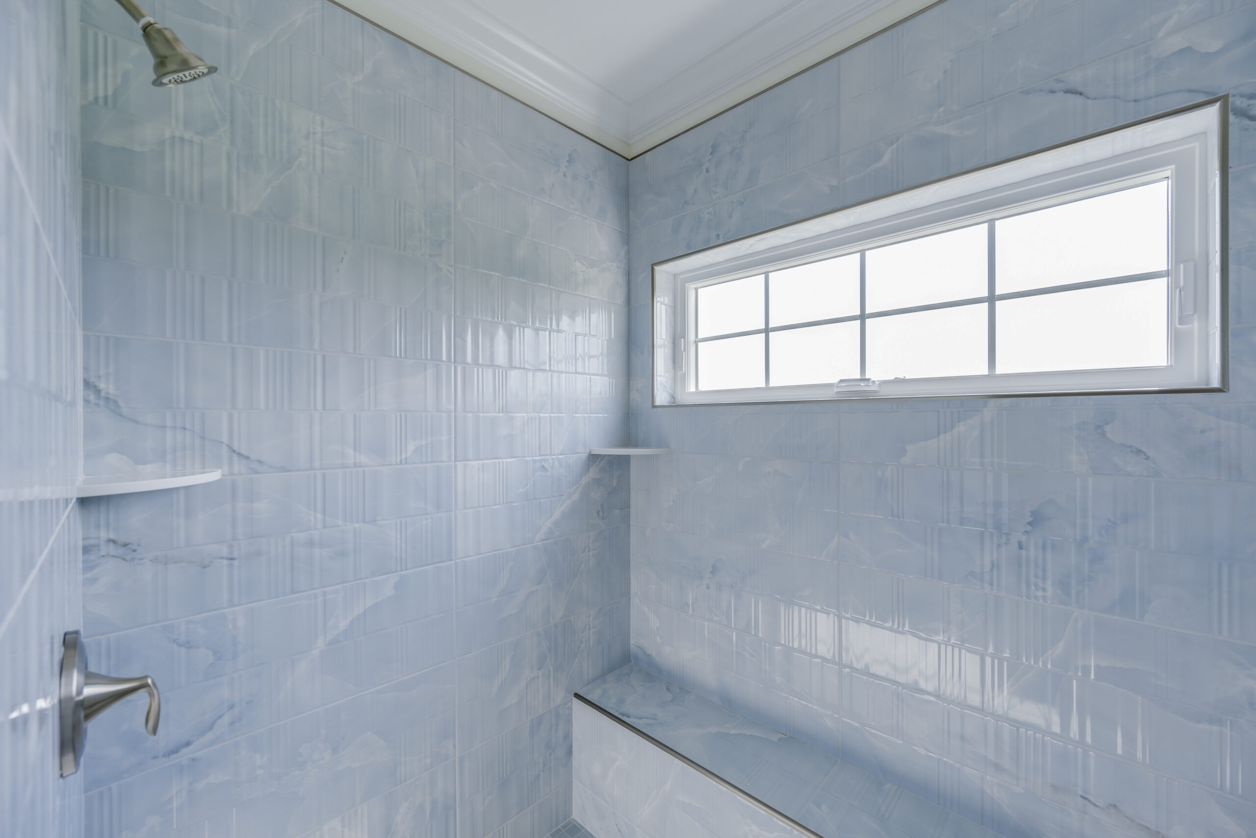 a bathroom with a shower and a window