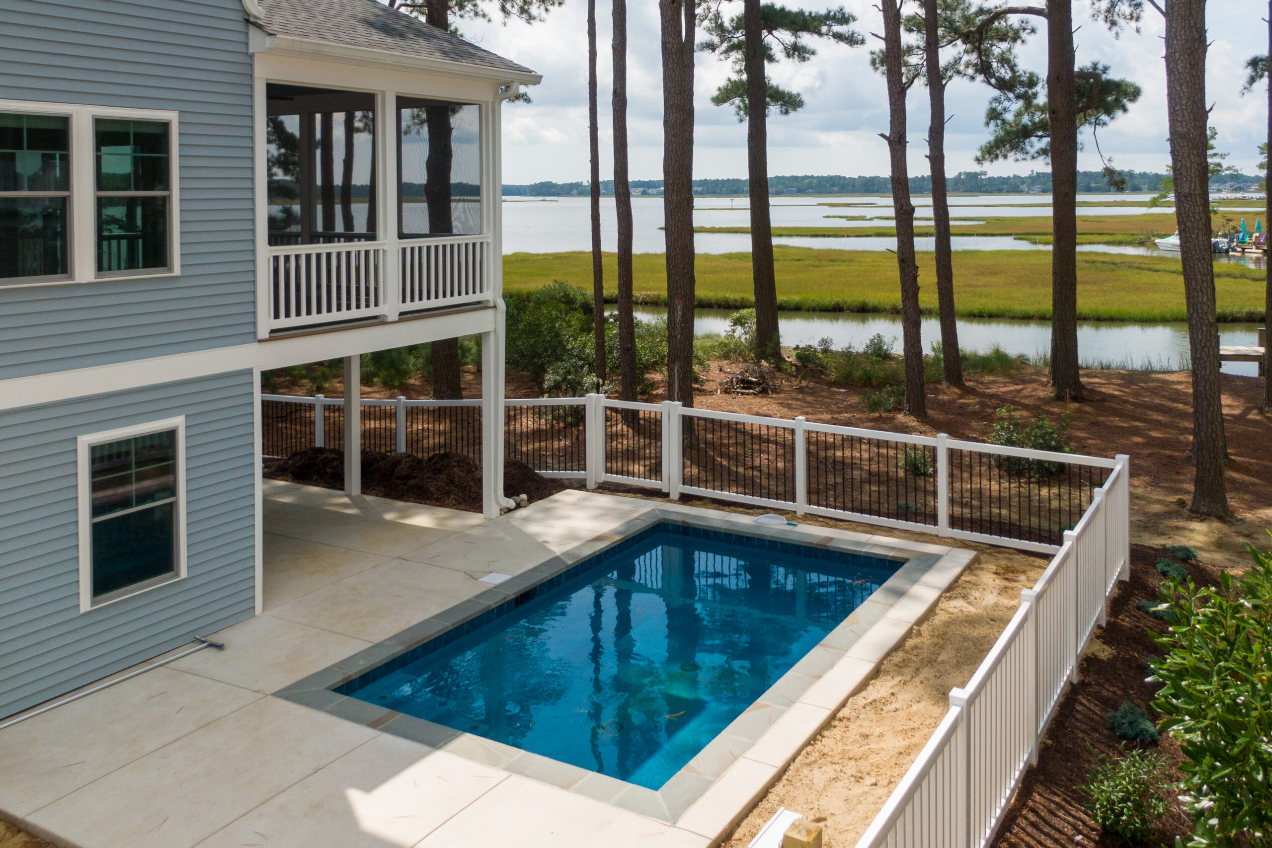 a house with a pool in front of it