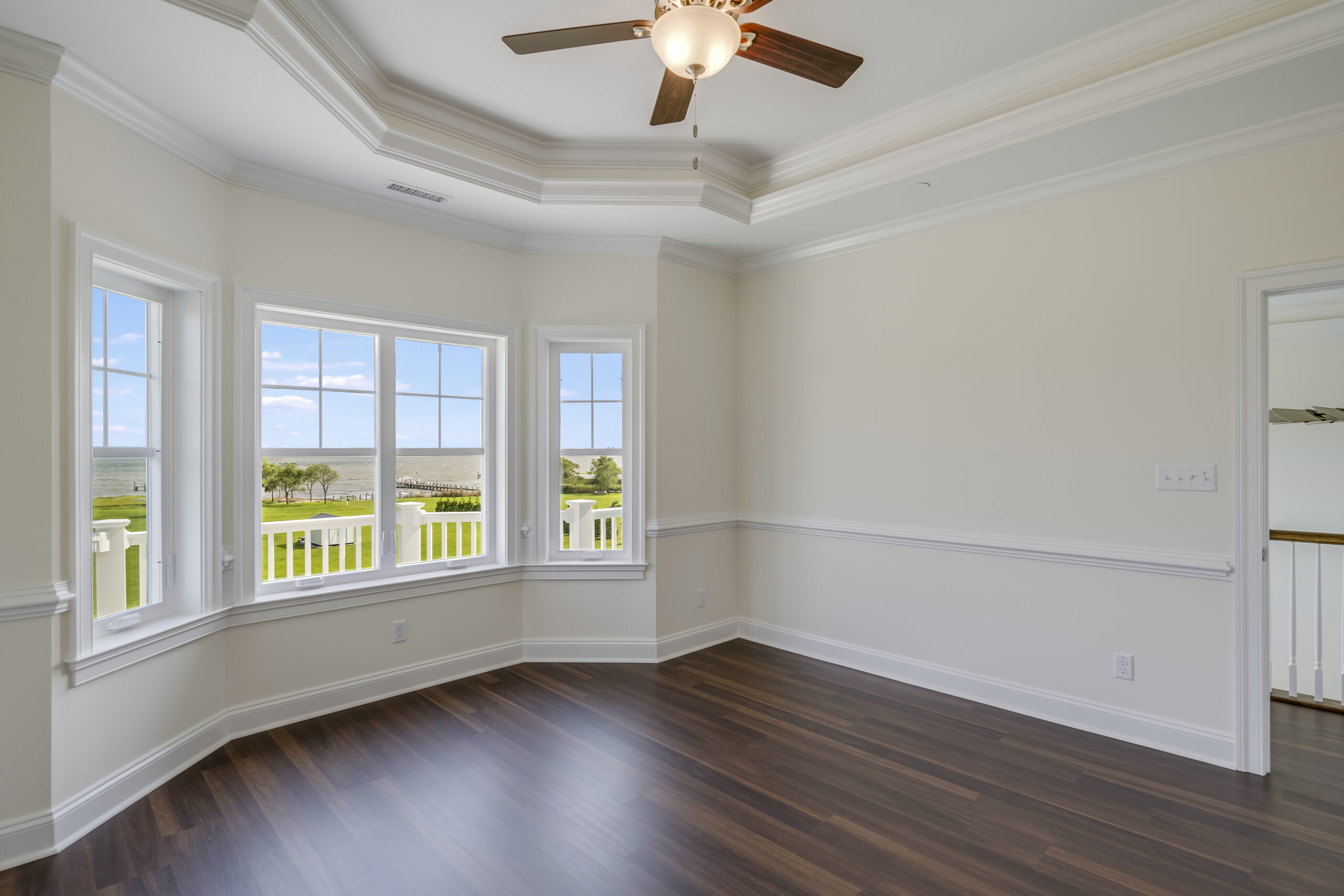 a large empty room with a ceiling fan