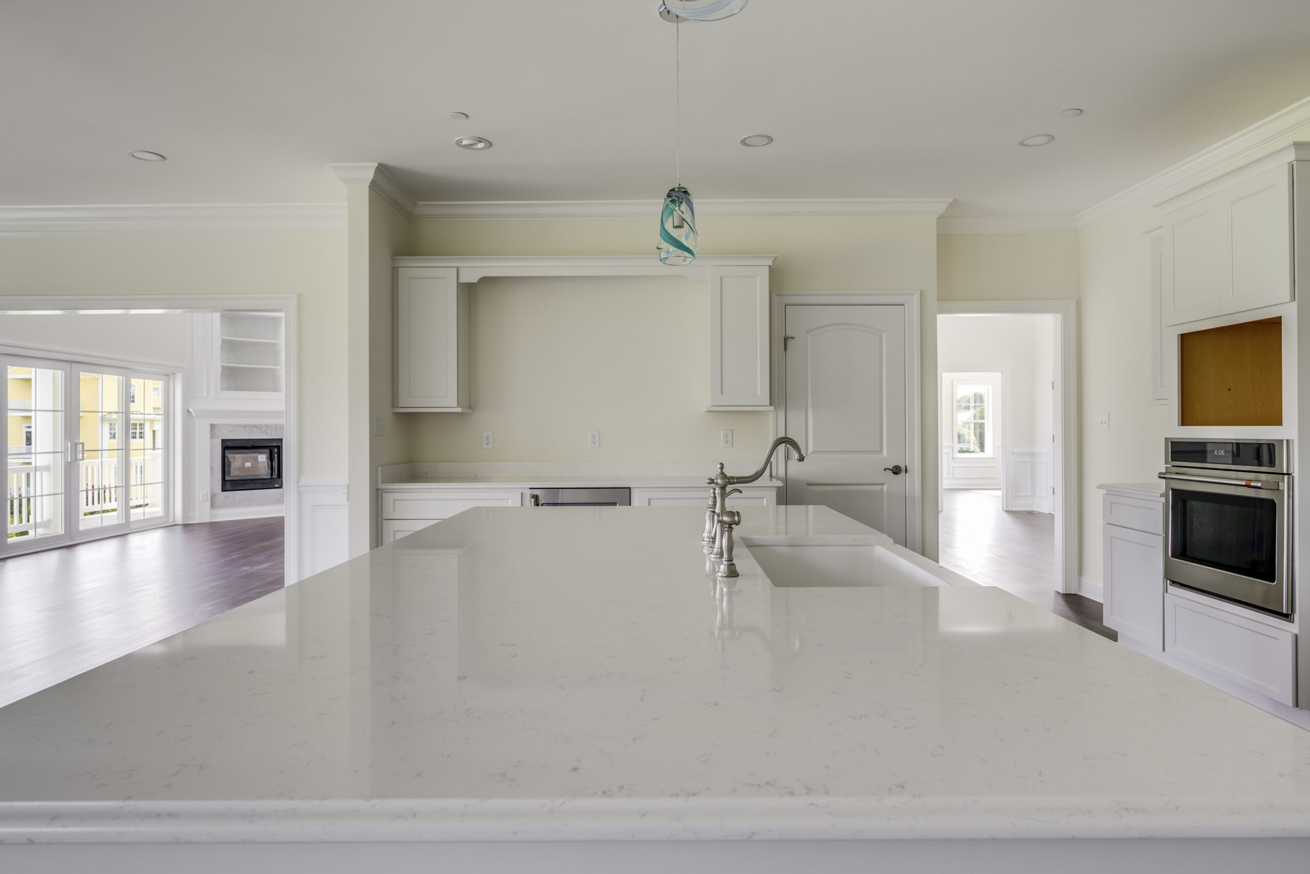 a large kitchen with a center island in the middle of the room